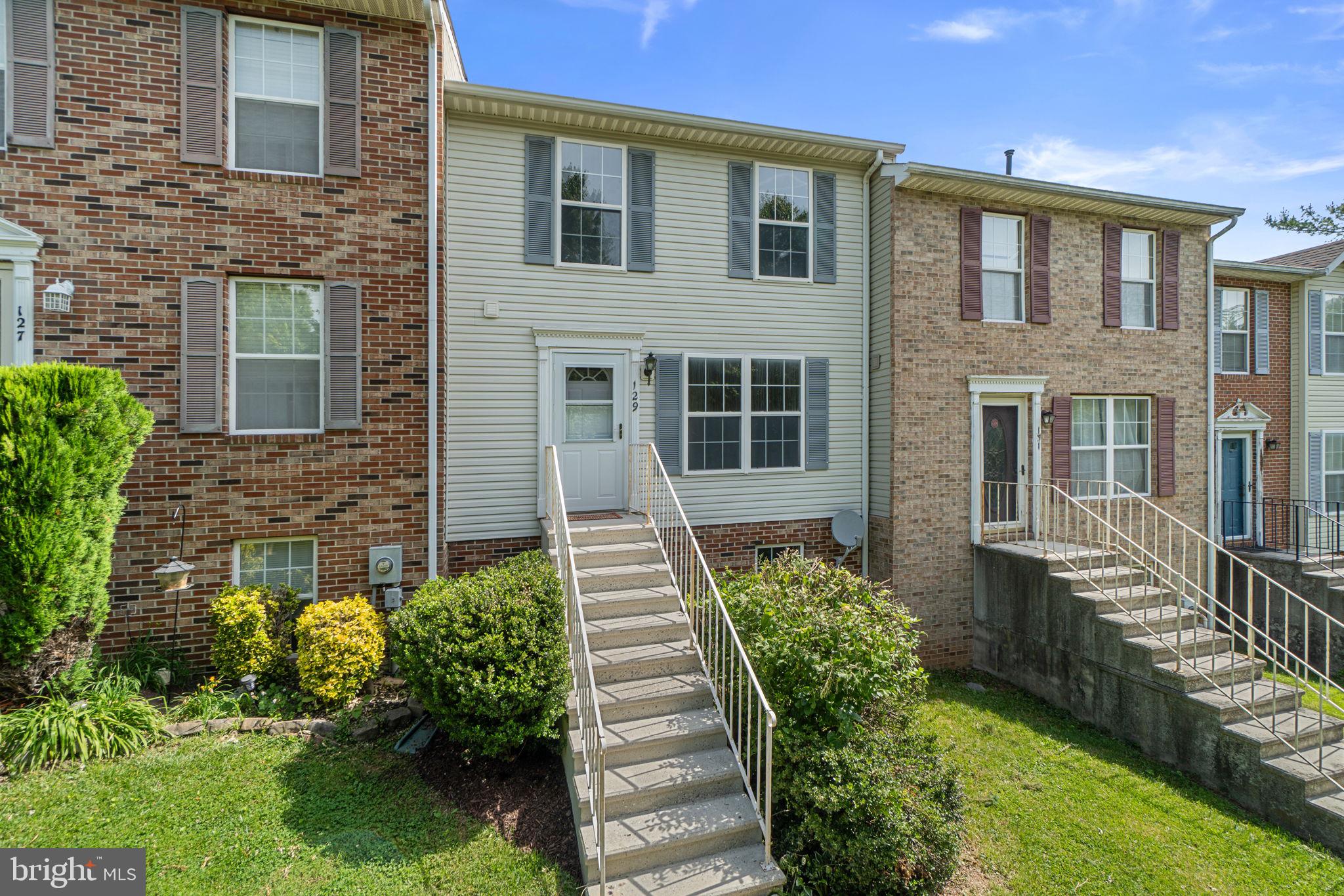 Welcome to 129 N Towne Court, located in the sought-after Mount Airy Manor community. Situated on a quiet cul-de-sac, this beautifully updated townhome is just a short distance from the shops, restaurants, parks, and community events found throughout downtown Mount Airy. The main level features new hardwood flooring and an updated kitchen with quartz countertops and stainless steel appliances. Also located on the main level are a convenient half bath and main-level laundry. Upstairs you'll find new carpet throughout, including the spacious primary suite with private bath, along with two additional bedrooms and a full hall bath. The lower level offers exceptional flexibility. The lower-level rear-entry garage has been converted into a studio complete with heating and air conditioning, making it ideal for a home gym, recreation room, hobby space, studio, or storage area. The space can easily be converted back to a garage if desired. The lower level also includes a half bath and an additional room with a full-size window that provides abundant natural sunlight, creating the perfect space for a home office, workout room, playroom, or additional living area. Additional improvements include a Carrier heating and air conditioning system installed in 2025, a 2024 hot water heater, and updated double-pane windows. Parking is available for two vehicles in the rear driveway. Just minutes from historic downtown Mount Airy, you'll enjoy everything that has made this community one of Carroll County's most desirable places to live.