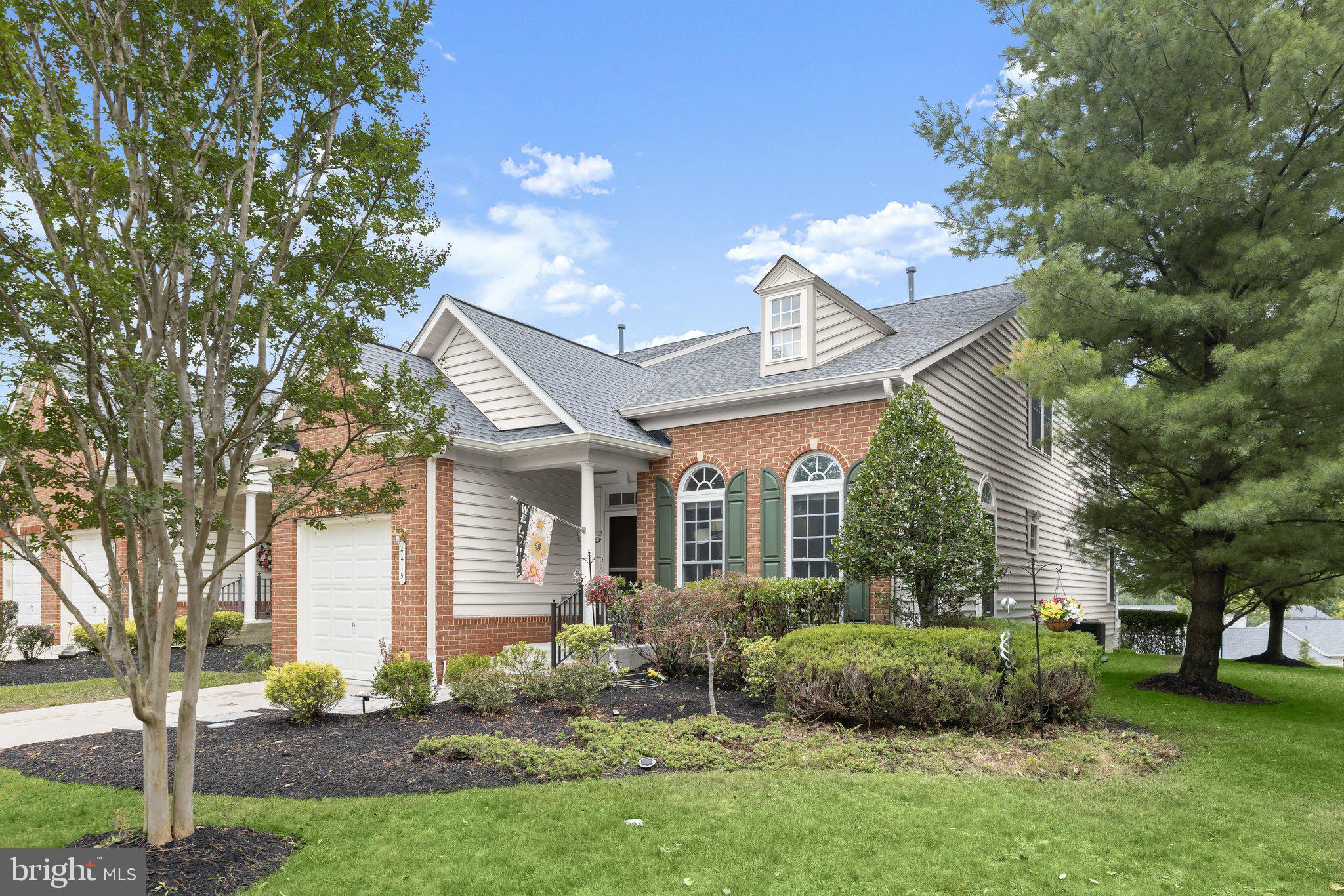 Introducing this stunning home in the sought-after Villages At Woodholme, a premier active-adult 55+ gated community that offers resort-style living and endless amenities. This end-of-group home features three levels of exquisite living with three bedrooms and three-and-one-half bathrooms. Inside, soaring ceilings and sun-filled windows create a bright, inviting atmosphere with rich hardwood floors throughout the main level. The front living room boasts a two-story vaulted ceiling with skylights, and the dining room is graced with elegant chair railing and an artwork lighting system. Prepare your favorite meals in the spacious eat-in kitchen that is equipped with stainless steel appliances, including a double wall oven and separate cooktop, granite counters, a backsplash, 42-inch cabinets, a center island with seating, and a pantry. Just beyond the kitchen, the sunroom with a vaulted ceiling provides a cozy spot to relax and has access to the deck, complete with a retractable awning for outdoor enjoyment. Located on the main level, the primary bedroom suite features a tray ceiling and a walk-in closet with organizers. The luxurious en-suite bathroom has a dual-sink vanity, a glass-enclosed walk-in shower with a bench, and a jetted whirlpool walk-in tub. Completing the main level are a half bathroom and a laundry room with storage cabinets, a wall-mounted ironing board, and access to the attached one-car garage. Upstairs, a versatile loft is ideal for an office, lounge, or reading nook, along with two additional bedrooms and a shared hallway full bathroom. The fully-finished lower level offers a massive recreation room with space for everyone to gather and a wet bar with a mini fridge and extra dishwasher. A versatile office could also serve as an additional bedroom with another full bathroom around the corner. The utility room and two storage rooms ensure you always stay organized. The gated community of the Villages At Woodholme offers a wide variety of amenities, including a community center with social events, library, meeting and media rooms, fitness center, and exercise room. Outdoors you can enjoy the pool, tennis and pickleball courts, putting green, patios, and gathering spaces. Recent updates include a new roof in November 2025 and new HVAC in June 2025.