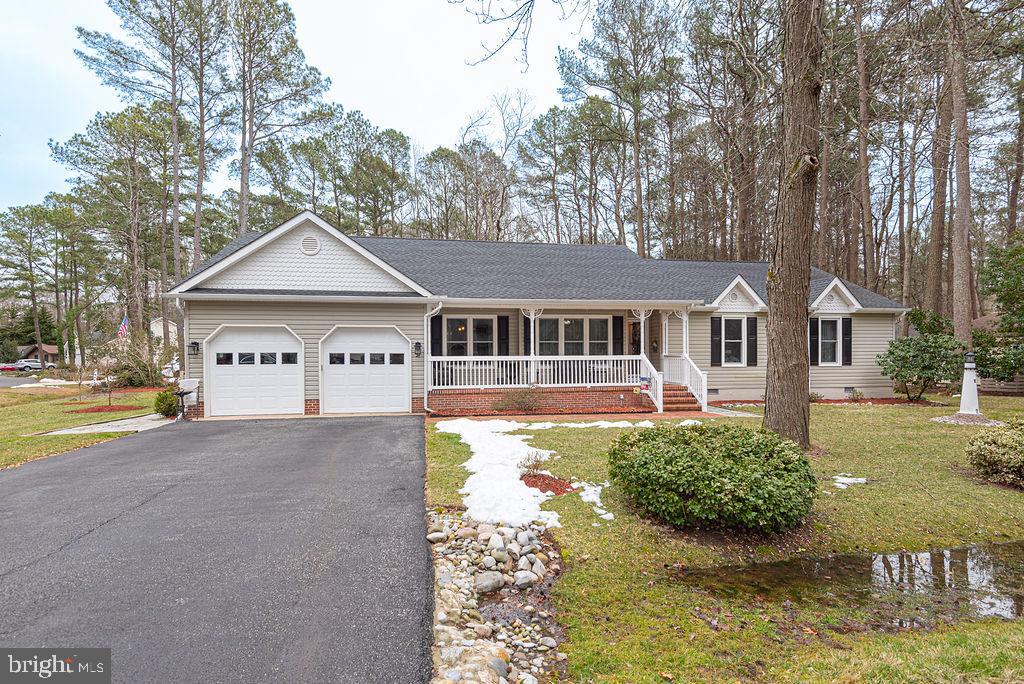 Picture yourself in this spacious 4 bedroom home with a fantastic setting, situated on an extra-large corner lot across the street from the Ocean Pines Golf Course! The brick front porch welcomes you with vinyl railings and a brick walkway.  You will find Luxury Vinyl Plank flooring throughout the many living areas, including the formal Dining Room, Sun Room, Laundry Room, Powder Room, Kitchen and Breakfast areas.  There are numerous upgrades  such as a Kitchen island with prep sink, granite countertops, stainless steel appliances, subway tile, gas cooktop, double Kitchen Aid wall ovens, chair rail, crown molding, glass barn door, and a gas fireplace.  Recent replacements are new cabinet fronts, Pella windows, encapsulated crawl space with dehumidifier, new roof in 2020, and new HVAC in 2019.  There are many disability-friendly features, such as a 4' wide hallway, 3' wide doorways,  swing-clear hinges, and walk-in tub with tile surround.  Don't wait to see this charming home located in the award-winning community of Ocean Pines, and just a short drive to the beaches of Ocean City,  Assateague Island and historic downtown Berlin!