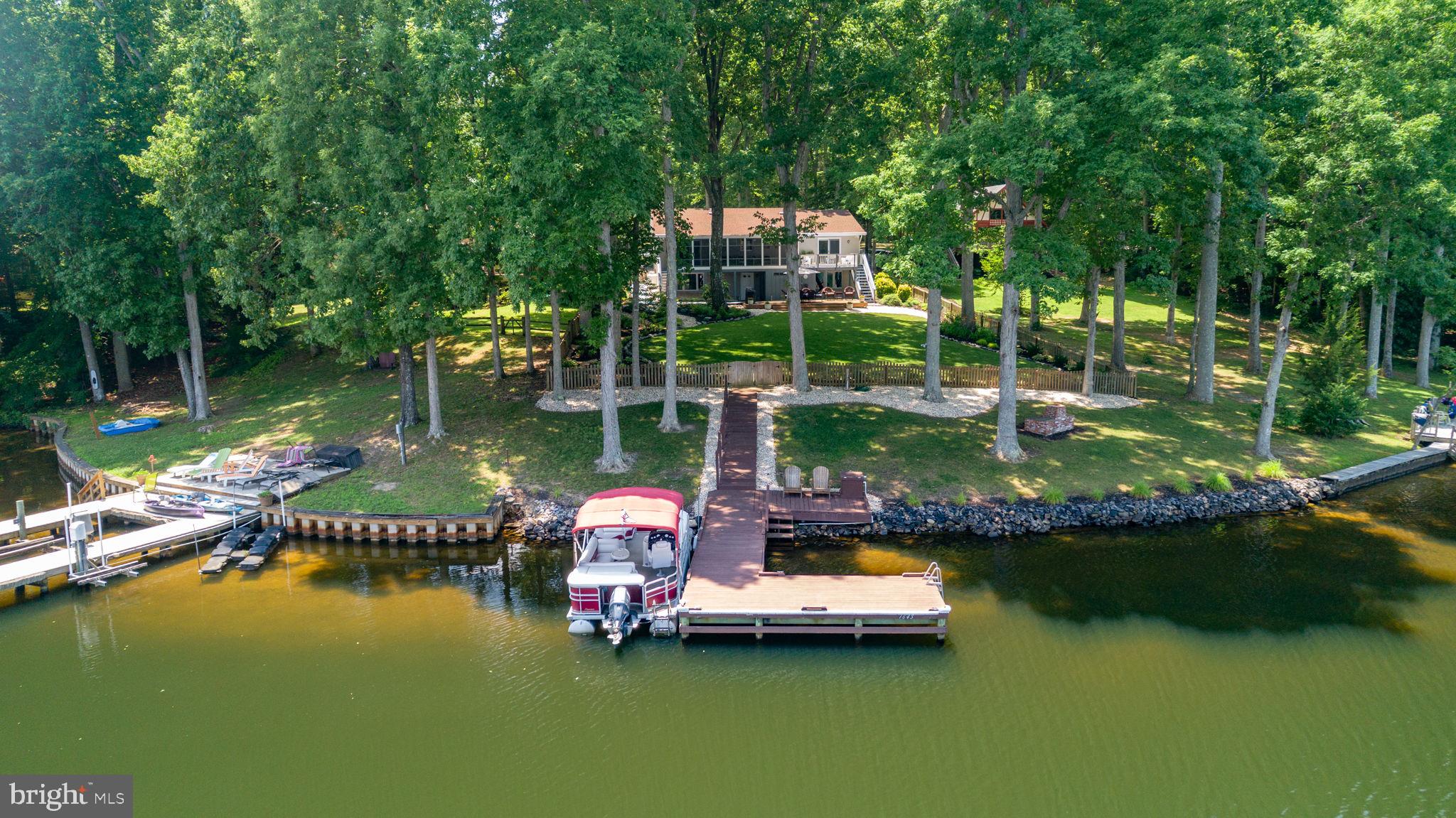 Rare Deep-Water Lakefront Living—Turnkey, Updated, and Ready for Your Next Chapter at Lake Caroline.”

Welcome to 280 Lake Caroline Drive, a private waterfront retreat where thoughtful updates, wide lake views, and true move-in readiness come together on one of Lake Caroline’s most desirable lots. Set on more than half an acre with breathtaking 180-degree lake views and deep-water access, this beautifully maintained home delivers the feel of a year-round resort with the comfort and practicality of everyday living.

A long paved driveway leads to the attached two-car garage, with generous additional parking for guests, boats, and recreational vehicles. Professionally landscaped grounds, extensive irrigation, and a fully fenced backyard create a setting designed for privacy, ease, and outdoor enjoyment.

Inside, the home has been extensively updated across both levels. Highlights include remodeled bathrooms, updated flooring, newer kitchen appliances, a 2024 HVAC system, 2022 water heater, and a whole-house water filtration system installed in 2025. (Full List of Upgrades is in Documents!)

Four large bay windows fill the home with natural light and frame spectacular water views from multiple rooms.
The main level offers comfortable living spaces and direct access to an elevated three-season porch overlooking the lake. The primary suite includes its own private balcony, an ideal spot for morning coffee, sunrise views, and quiet evenings by the water. Two gas fireplaces add warmth and character on both levels.

The finished lower level offers excellent flexibility for guests, extended stays, multigenerational living, remote work, hobbies, or entertaining. This level features a spacious family room, large bedroom, full bath, kitchenette, two bonus rooms, one currently used as a fourth bedroom, and additional storage space.

Outdoor living is where this property truly shines. Enjoy an oversized lakeside deck, expansive lawn, attached storage shed, and private deep-water dock ready for boating, fishing, swimming, kayaking, paddleboarding, and quiet days on the water. Active lawn care and HVAC service contracts convey to the new owner, adding convenience from day one.

Lake Caroline offers an outstanding waterfront lifestyle with a 277-acre full-service lake, two sandy beaches, swimming pool with lifeguards, clubhouse, playgrounds, tennis courts, pickleball courts, basketball courts, fishing, boating, water skiing, wakeboarding, jet skiing, kayaking, paddleboarding, and year-round community events.

This is an exceptional fit for a full-time residence, relocation to the area, second home, weekend retreat, or move-up waterfront purchase. Located within a gated, amenity-rich community just minutes from I-95, shopping, dining, and schools, 280 Lake Caroline Drive is a rare opportunity to own one of Lake Caroline’s standout waterfront properties.

Nothing left to do except move in and start enjoying lakefront living.