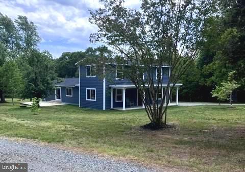 Your dream come true! This newly renovated 1890's 3600 sq. ft. farmhouse sits on 7 private acres and is located within minutes of downtown Mineral. Also included is a recently updated 2 BR brick rancher perfect for use as a stand-alone home for extended family, a guest house, or as rental property to generate additional income. Wooded road-frontage and a gated driveway lead to a clearing where the home is surrounded by mature trees and a beautiful grassy lawn. This home was rebuilt starting at the original foundation and studs and thus presents as a brand-new build with hardwood flooring, two first floor bedrooms with private on suites each with a walk-in shower. A large foyer and living room area leads to an open-concept kitchen-dining-family room with sliding doors and large windows for lots of natural light. The airy kitchen features plenty of cabinets with quartz countertops, a large island, and brand-new stainless-steel appliances. The second floor includes an expansive rec room, large bedroom, full bath, and space great for an office or reading nook. A newly constructed composite deck on one side of the home and a patio on the other ensure easy access to enjoyment of the outdoors. Two hot-water heaters, a whole-house generator, a water filtration system (with an added UV filter), and two brand-new HVAC (3 ton and 1.5 ton) units service the main home. The rancher has been recently updated and features 2 bedrooms, 1 bath, kitchen, family room with fireplace, a utility room, and a new deck, The main home features a whole house generator while the rancher includes a back-feed setup with portable generator. This is a property that truly must be seen to be appreciated as it is a haven for wildlife, boasts mature black cherry trees, pear, peach, apple, and mulberry trees, raised garden beds, a shooting range with protective berm, and a large run-in shed great for equipment storage or perhaps as a shelter for chickens, goats, or even a couple of horses. For someone interested in expanding this property, there is potential for future purchase of an additional 12.4 adjoining acres. This amazing property is conveniently located within 5 minutes of the quaint Towns of Mineral and Louisa and approximately 10 minutes of Lake Anna offering boat launch and on-water and off-water boat storage, Food Lion, convenience shopping, multiple restaurants, putt-putt golf, ice cream, wineries, breweries and Lake Anna Taphouse.