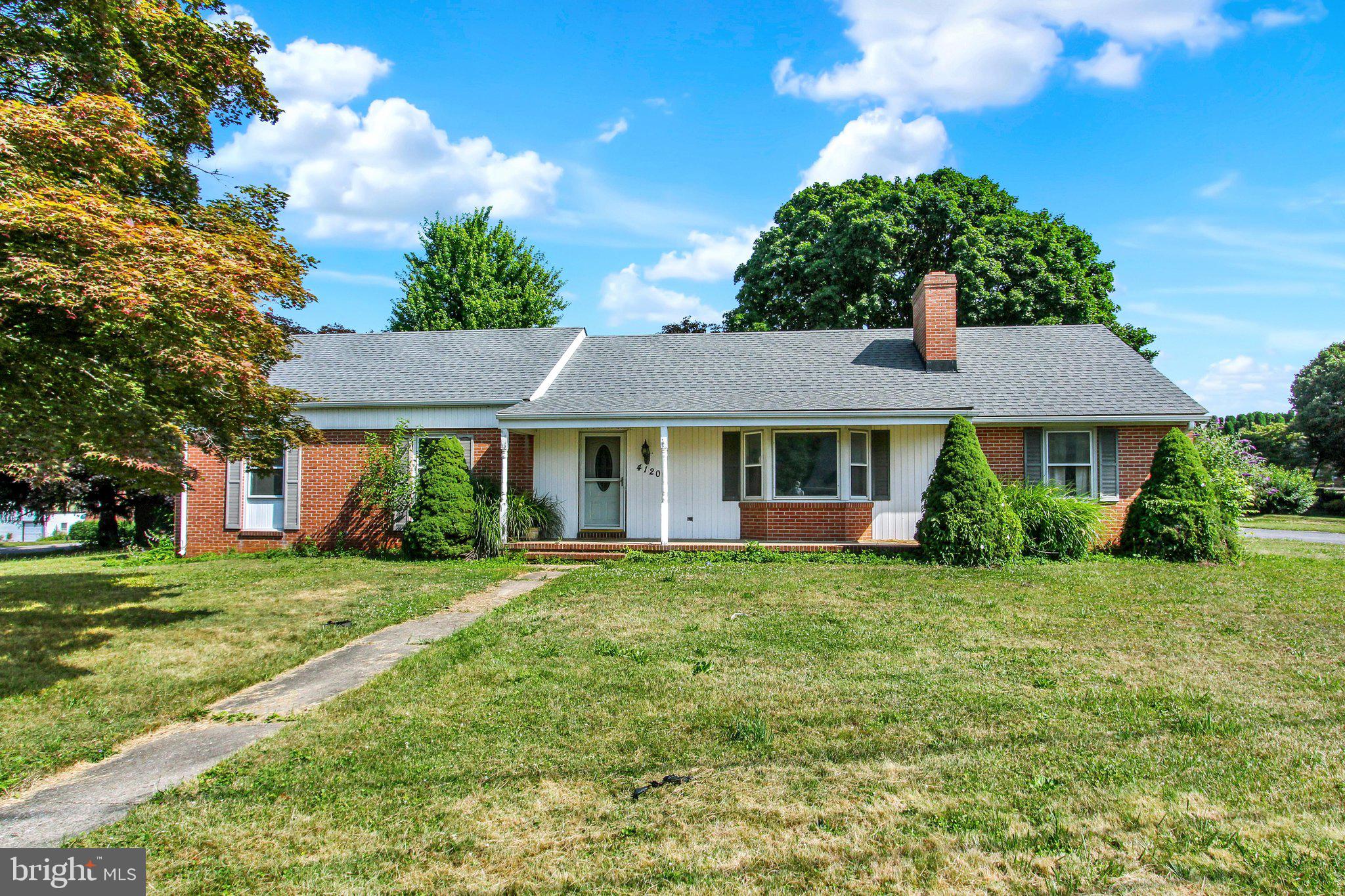 Solidly Built Brick Rancher on 0.55 Acre level lot in a convenient Hampstead location!   This 3 bedroom, 2 full bath home offers one-level living with wood floors on much of the main level.  Generous primary bedroom includes attached full bathroom with shower stall.  Additional bedrooms are decently sized, and all bedrooms feature hardwood floors.  Spacious living room with hardwood floors hosts a brick framed fireplace to cozy up to in the winter.  Kitchen offers ample storage and a dining area that leads to a 3-season sun room.  Enjoy the convenience of a 1-car garage and plenty of off-street parking.  Bring your vision and make it your own - paint will go a long way in this well built brick home!   Roof (2019), water heater (2024), and well pump (less than 5 years old) offer some peace of mind on major systems.  Walking distance to Main Street shopping and dining, and community parks!