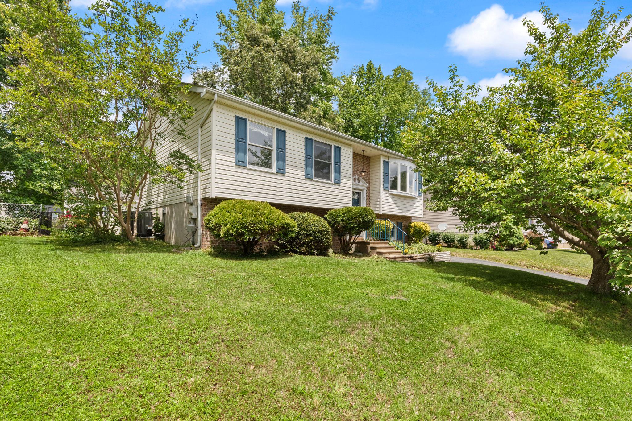Charming 3-bedroom bi-level home in the desirable Northwoods community — move-in ready with recent updates including a 2020 roof, 2018 HVAC, and 2022 sump pump. The main level features a primary bedroom with private full bath, a second bedroom, an additional full bath in hall, plus an eat-in kitchen that flows to a tiered deck overlooking a fully fenced yard — perfect for outdoor entertaining. The lower level offers a comfortable living area with wood burning stove, third bedroom, a full bath, laundry room and has a ground-level entrance. This property incudes two outdoor sheds. The larger shed has electrical service and was used by the seller as a "She-shed" offering endless ideas to create a personal space. Showings are easy to schedule and quick settlement is available!