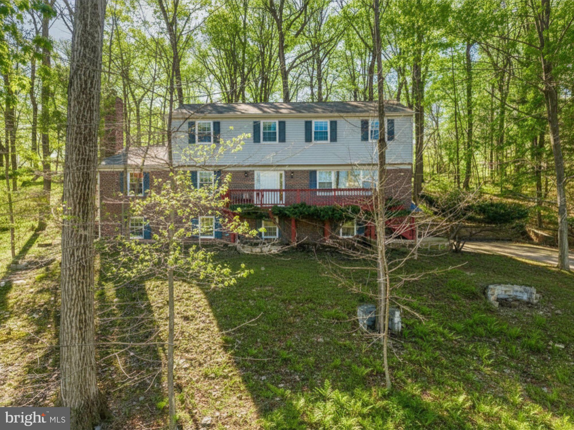 Exceptional value in East Goshen! Ideal for the buyer who wants a move-in-ready home on a large lot with the potential to be configured to meet their needs and (landscaping ) vision. This is a rare opportunity in a sought-after community. You’ll enjoy the best of both worlds with this spacious, beautifully maintained home, offering unmatched privacy, pastoral views, and all the amenities of the popular Charter Chase community, including a pool, clubhouse, pond, and tennis courts. Perched on a private, wooded one-acre lot with gentle slopes and steps to the main entry, this four-bedroom, two-and-a-half bath home offers over 2,800 square feet of living space, plus a 400+ SF finished lower level, lovingly maintained and updated by its owners of more than 45 years. Beautiful hardwood floors flow throughout most of the main level, and replacement Andersen windows fill the home with natural light. A large formal living room features a picture window with sweeping views of preserved open space. Opposite, an inviting family room with warm paneling and a wood-burning fireplace creates a cozy retreat. The eat-in kitchen — with granite countertops, marble backsplash, updated soft-close cabinetry, and stainless appliances including a convection microwave — is perfectly outfitted for everyday dinners or hosting a crowd, and opens to a generous dining room with chair rail detail. A large slider in the breakfast area leads to the back patio and serene wooded views. Also on the main level: a roomy office with shelving, efficient laundry with a utility sink, and a powder room. The finished lower level — above grade, with brand-new lighting and carpeting — is an enormous, flexible space ideal for a playroom, home office, workout room, or media room, with direct access to the oversized two-car garage. Upstairs, the primary suite features a walk-in closet and an updated en-suite bath with a new marble double vanity and upgraded shower. Three additional well-sized bedrooms and a full hall bath with a new marble double vanity complete the second floor. Outside, a front deck captures sunset views over rolling hills, while an expansive brick patio just off the kitchen is perfect for relaxing or entertaining. The home also features a whole-house generator, newer vinyl siding, a high-efficiency AC system, a new roof (2023), 200-amp electrical service, and Andersen replacement windows throughout. Conveniently located minutes from major routes, train stations, shopping, dining, and parks — and all that West Chester and Malvern Boros have to offer. This is not a drive-by…make your appointment to tour today!