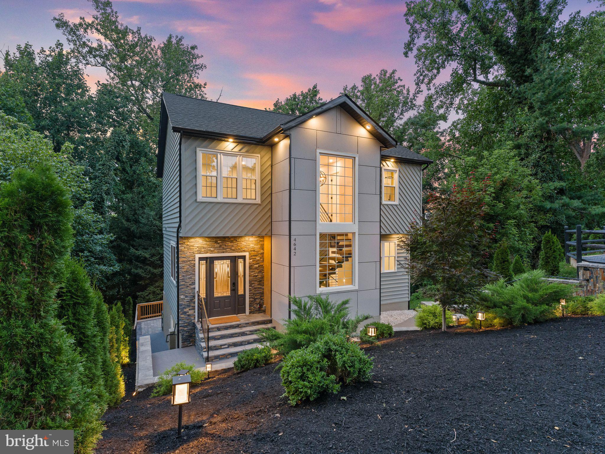 Perched Above the River were Modern Luxury Meets Nature in Belmont Hills , Welcome to 4642 Belmont Ave—a masterfully renovated and expanded retreat sitting high atop a lush, wooded hill in Bensalem. Rebuilt on its original foundation  and expanded to create an architectural masterpiece, this 4-bedroom, 4-bath home (plus dedicated office/den) offers an extraordinary blend of privacy, natural beauty, and modern design. Step inside to an airy, light-filled open concept framed by gorgeous laminate floors and custom recessed lighting. At the center of it all is a chef’s dream kitchen featuring Crisp white cabinetry paired with quartz countertops and a massive center island Glass subway tile backsplash, floating display shelves, and an extra-large farmhouse sink Modern pendant accents and high end appliances, complete with a built-in wine fridge. Effortlessly transition from indoor dining to outdoor living as sliding glass doors lead out to an oversized, custom-lit deck overlooking peaceful river views, mature trees, and local wildlife. A sleek main-level powder room completes this floor. Follow the striking floating lighted staircase to the upper level, home to three spacious bedrooms. The serene primary suite serves as your private getaway, featuring a stunning modern ensuite bath. The walk-out lower level expands your living options with a fourth bedroom, a private home office, a cozy family room/flex space, and a full bath. Step through to an expansive stone patio with modern LED lighting—perfect for twilight gatherings in your meticulously manicured, treetop oasis. Experience elevated living in harmony with nature. Schedule your private walkthrough today.