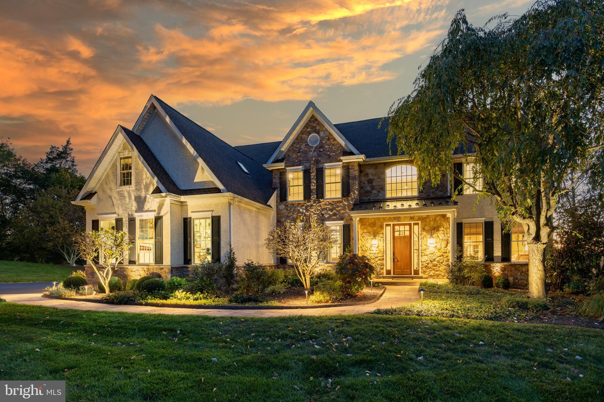Welcome to 540 Landis Road-the home you have been waiting for. Nestled on a private, tree-lined 2.19-acre lot with a long driveway, this 5,830 sq. ft. estate seamlessly blends timeless craftsmanship with modern luxury. Offering exceptional privacy and stunning views, the residence showcases elegant design, premier upgrades, and meticulous care by its original owners—now awaiting its next chapter. The first floor begins with a dramatic two-story foyer and a thoughtfully designed layout. At its center, a gourmet kitchen features a Viking Professional 7-Series built-in double French door oven, new stainless-steel microwave (2025), Bosch stainless steel dishwasher (2024), Cambria quartz countertops, new deluxe refrigerator (2024), custom  Decora cabinetry, designer lighting, and Lutron app-controlled illumination. The kitchen opens to a light-filled eating area with skylights and deck access, as well as a spectacular two-story family room with fireplace and custom Cambria quartz bar—complete with Hunter Douglas power shades. Formal living and dining rooms, both with custom moldings and coffered ceilings, provide refined spaces for gatherings, while a private library offers flexibility for a home office. Wide-plank natural hickory hardwood flooring flows throughout much of the main level, uniting each space with warmth and sophistication.  The upper level boasts an oversized primary suite with sitting area, dressing area, and expansive walk-in closets. Its spa-inspired ensuite bathroom offers heated flooring, a freestanding Picasso Maestro thermal air tub with heated backrest, digital shower controls, custom tiled shower and Hunter Douglas Vignette power Roman shades. Three additional bedrooms and two full bathrooms complete this level. The fully finished, walkout basement is an entertainer’s dream, offering a custom-built bar, theater room, exercise room, art area, full tiled bathroom, and a generous storage area that also includes GE Profile double ovens (for large gatherings or parties), countertop space, and cabinetry. Abundant storage and thoughtful design make this level as functional as it is impressive. The resort-style backyard is the crown jewel of this estate. A Trex deck with LED recessed uplighting, Trex Transcend railing with LED lighted posts, Montego stone fireplace with remote and two additional electric heaters mounted, and a spacious, vinyl pergola creates an exceptional outdoor living space, while Trex Rain Escape waterproofing makes the stone patio below equally inviting. The deck overlooks the in-ground pool with attached hot tub, fully resurfaced in 2021 with new tile and a waterfall spillway wall, upgraded LED lighting (2025) in pool and hot tub, all enclosed by an ultra-aluminum fence with three single gates and one double gate. Surrounding flagstone walkways, stone patios, lush perennial beds, and extensive hardscaping enhance the professionally landscaped, fully irrigated, landscaped grounds—an easy to maintain outdoor oasis designed for both relaxation and entertainment. Complementing these features is a curated list of upgrades and systems that elevate comfort and convenience: an Ackerman wired security system, Sonos whole-house audio extending from the pool and patio to the basement, kitchen, breakfast room, library, theater and primary suite bath, Lutron smart lighting, Focus landscape lighting, a Rainscape Wi-Fi 9-zone irrigation system, whole-house water filtration with chemical feed, a chandelier lift system, new roof (2025), with a 50 year transferable warranty, and new Velux skylights (2025), driveway seal coating (2024), a Fujitsu 4-zone ductless heat pump system (2018), and newly replaced first- and second-floor  A/C & Carrier High Efficiency heat exchangers (2025). Additional highlights include an oversized, side-entry 3-car garage with oversized doors and a new shed (2025).  Please note Ring recording /monitoring devices on premises.