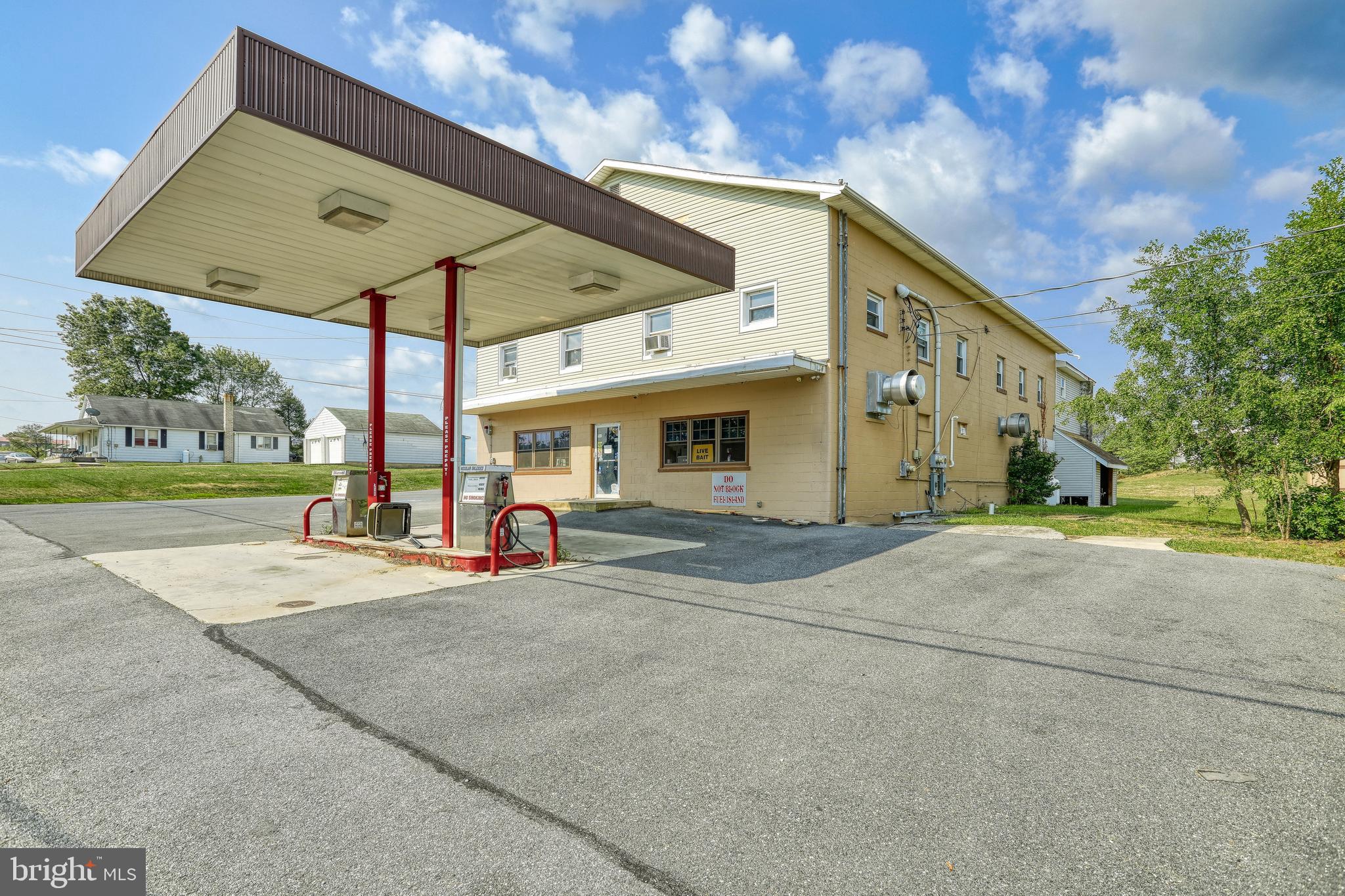 Alert!!  Investment opportunity!!  This commercial building comes with a store ,  two apartments,  a garage and plenty of parking spaces.  Has working gas pumps but tank may need re-certified.  One apartment has 3 bedrooms and 1 bathroom and the other apartment has 2 bedrooms and 1 bathroom that recently was renovated.  Store  has various types of  refrigerators for cold beverages, cold meat etc..  A large fryer and a large flat top grill.    The opportunities for this property are endless!
