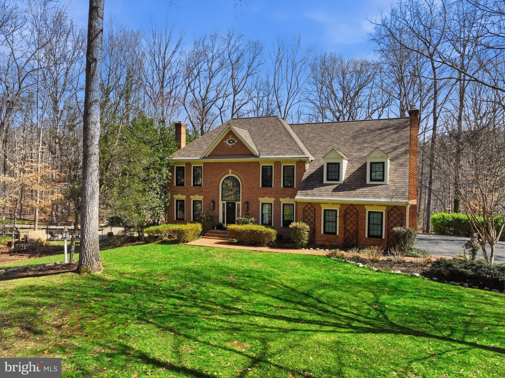 Welcome to your private retreat in the heart of Fairfax Station, a breathtaking estate perfectly situated on 1.28 acres backing to serene woods for unmatched privacy and natural beauty. This gorgeously updated home showcases top-of-the-line finishes, impeccable styling throughout, and thoughtfully curated details.The main level offers two inviting living rooms, each with its own cozy fireplace, a separate formal dining room, and a private home office complete with custom built-ins. The spacious kitchen features a large center island, additional bar seating, and an eat-in area wrapped in wall-to-wall windows overlooking the peaceful, wooded lot. Just beyond, enjoy the screened-in porch and great room. From the kitchen, walk out to the tiered deck that steps down to the pool and side yard. Off the two car garage, walk into the convenient mudroom, complete with a bench and cabinetry and hooks for storage. Upstairs, the spacious primary suite offers an ensuite bath with a soaking tub, glass-enclosed shower, and double vanities. Two walk-in closets plus additional closet space provide exceptional storage, and don’t miss the hidden bonus room tucked off the primary closet, ready to create a dream flex space. Three additional sizable bedrooms, an updated hall bath with double sinks, and laundry complete the upper level. The fully finished lower level is designed for recreation and retreat, featuring a spacious rec room with walkout access to the backyard, additional laundry, a full bath, den/bonus room, a moody movie room, and a dedicated home gym with rubber flooring. The cedar closet and additional under stair storage area provides ample storage space in the lower level. Step outside to your own private oasis: a heated 12-foot-deep pool surrounded by a stone patio and secured with a pool fence, all set against tranquil views. Pool has a shallow end and a Baja porch to sit with your lounge chairs. Large, attached outdoor storage closet. Over $200,000 worth of upgrades in the past few years, including Black Framed Pella Windows 2021. Roof 2023. 3 HVAC units in the home - two replaced 2019 and 2021. Pool fence 2019. Close to charming downtown Clifton. Take the neighborhood walking/jogging path to get directly to Burke Lake Park! Quick commuter convenience with easy access to the VRE, Fairfax County Parkway, 66, and 123