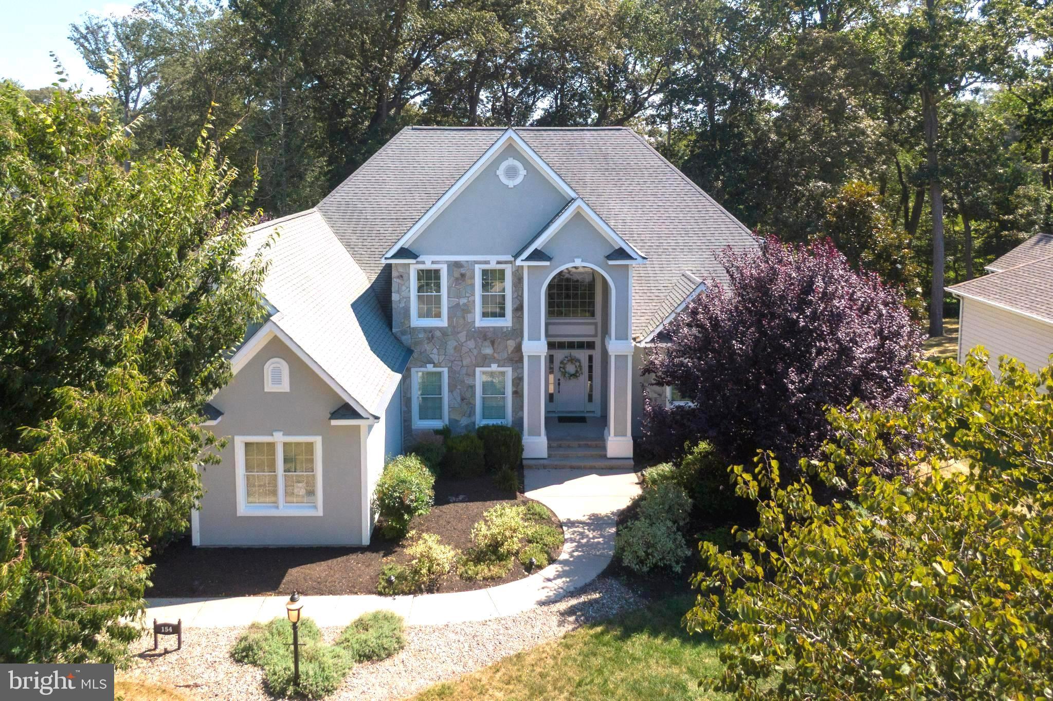 Discover an impressive and tastefully renovated .58‑acre pond‑front custom home in the well‑established Wagamons West Shores community in Milton, Delaware. This beautifully updated residence has been completely remodeled with brand‑new carpeting and premium upgrades throughout. The expansive two‑story layout offers six bedrooms and three and a half baths beginning with a grand entrance that opens into a bright open floor plan enhanced by new luxury engineered hardwood and tile flooring, a welcoming fireplace and a stunning four‑season room that leads to a spacious first‑floor balcony overlooking Wagamons Pond. The home features a completely redesigned upscale gourmet kitchen with striking quartz countertops, brand‑new stainless steel appliances, an elegant formal dining room and a stylish dry/wet bar ideal for entertaining. The first‑floor primary suite provides a private retreat with direct access to the rear balcony, a second fireplace, dual vanities, his‑and‑hers walk‑in closets, a sunken jetted tub and a walk‑in surround shower. The second floor offers five generously sized bedrooms all with new carpeting along with two Jack‑and‑Jill bathrooms and an additional balcony that captures elevated views of the pond. An oversized garage accommodates large vehicles with ease and the extended driveway provides ample parking for residents and guests. With very low HOA fees and a location in a quiet established community in the historic town of Milton—just minutes from beaches, restaurants, and shopping—this fully renovated home presents a rare opportunity to enjoy luxurious pond‑front living in a truly exceptional setting. Don't miss this fantastic opportunity. Several Photos are Staged.