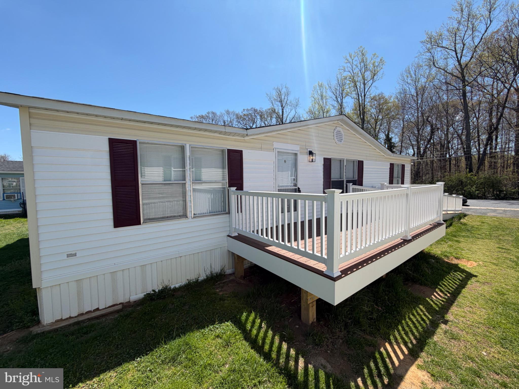 Beautifully updated doublewide in a quiet private community featuring a spacious open floor plan. Recent upgrades include a new roof, HVAC, hot water heater, LVP flooring, lighting, and fresh paint throughout. Renovated kitchen with new appliances and updated bathrooms. Laundry/mudroom with additional storage and washer/dryer included.
Split-bedroom layout offers privacy, with the primary suite located opposite the guest rooms and featuring a walk-in closet and updated bath. Recently installed ramp entrance, wide doorways, and walk-in double shower with safety rails.
Peaceful lot backs to open space and woods, with off-street parking and additional street parking available. Shed included. Community amenities included in lot rent: water/sewer, trash, snow removal, playground, and basketball area. Located near a wildlife estuary with walking trails, fishing spot, and water views nearby. Park approval required. * Professional Photos will be posted this week *