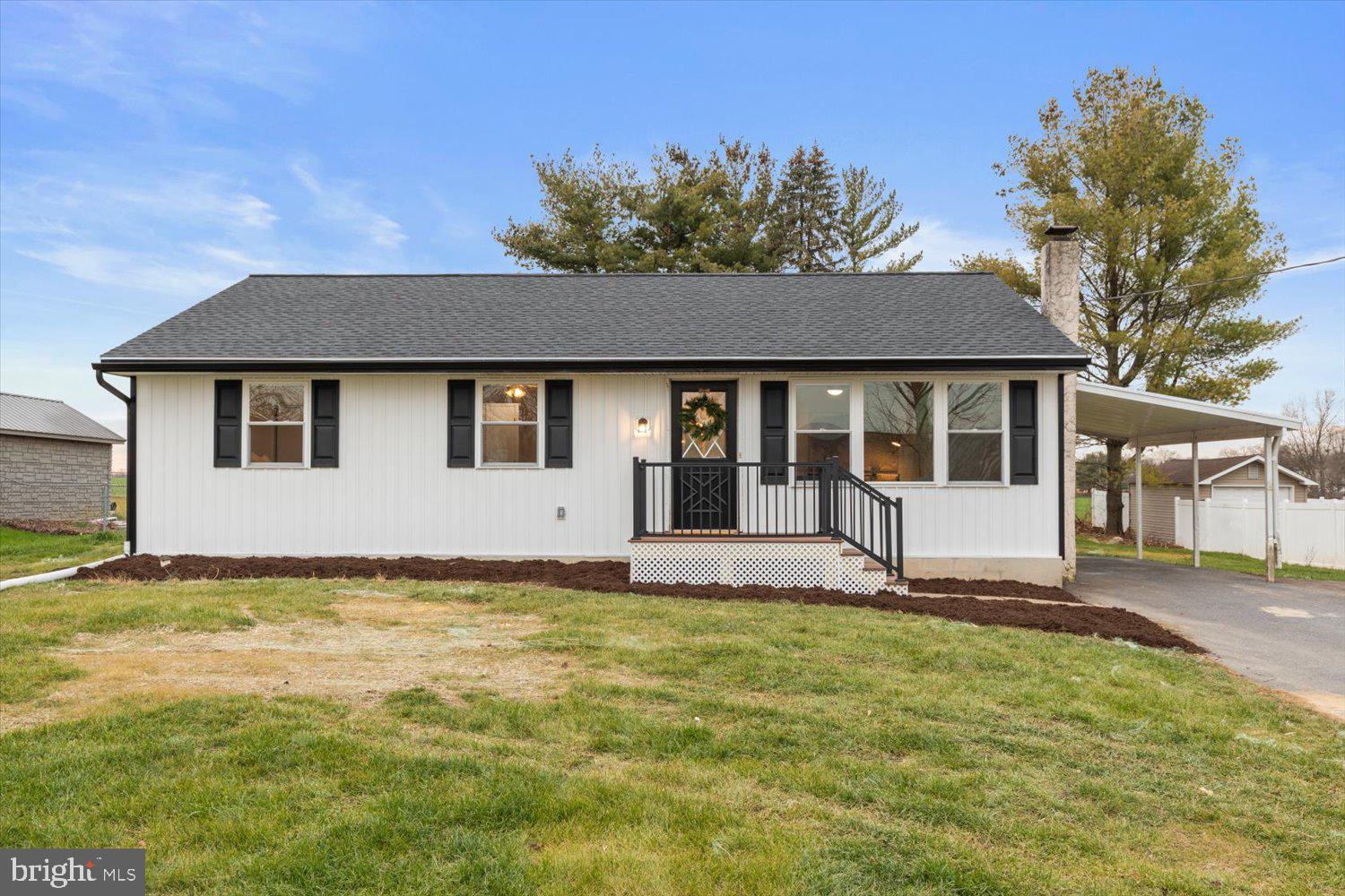 Welcome to 2216 High Street! This beautiful 3 bedroom, 1 bathroom, low-maintenance rancher with a carport is located on a flat open lot, and has been updated from top to bottom! This home is located on a quiet street and backs up to a farm which offers a lot of peaceful charm. You’ll love the traditional floor plan as you enter the home, complete with a large bay window providing tons of natural light throughout the space and luxury vinyl plank flooring. The living room is completed by a cedar accent wall which adds character to the room. The living area flows seamlessly into a brand new, high-end kitchen featuring white shaker cabinetry, stainless steel appliances, subway tiling, and open shelving. Off the dining room, step into the finished porch which includes 11 brand new windows and serene views. In the bedroom wing, enjoy 3 cozy bedrooms and a beautiful family bathroom with an elegant vanity, and a window letting in natural light. The partially finished basement with recessed lighting and brand new drywall spans the full footprint of the house and allows for a great space to not only store personal belongings but also finish completely in the future. Outdoors, the spacious backyard backs to a preserved farm for maximum privacy and the flat space is perfect for any pets. Enjoy living with very little maintenance due to your new electric baseboard heat, replacement windows, shingle roof, and white vinyl siding. Vacant and easy to tour - come take a look!