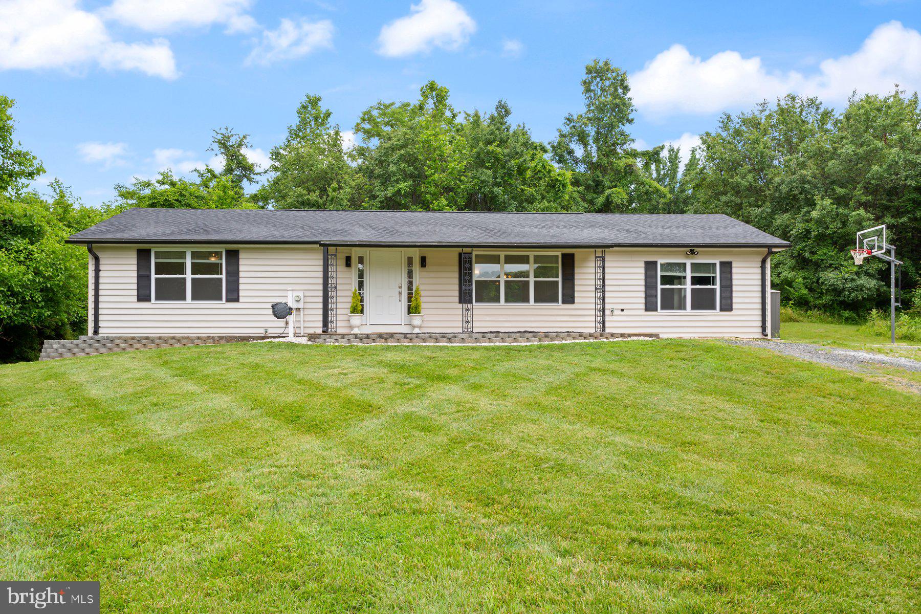 *** 30k Price Reduction ***  Fully updated and spacious 3 bed/2.5 bath rancher offering a new kitchen with white shaker cabinets/SS appliances/granite countertops/tiled backsplash, updated bathrooms and freshly refinished solid oak hardwood floors throughout!  There are two spacious bedrooms at one wing of the home with an oversized owners suite at the other end of the home  that offers a large walk in closet & on-suite bath.  The lower level is fully finished with a half bath and has access to the rear yard.  The home also features an energy efficient heat pump furnace w/propane backup (propane tank currently has been removed), all new double pane windows, a brand new roof, new ac and new siding with new exterior insulation & exterior thermal wrapping!  This is a nearly new home from inside to the exterior with a private setting sitting next to a large wooded parcel owned by the county.
