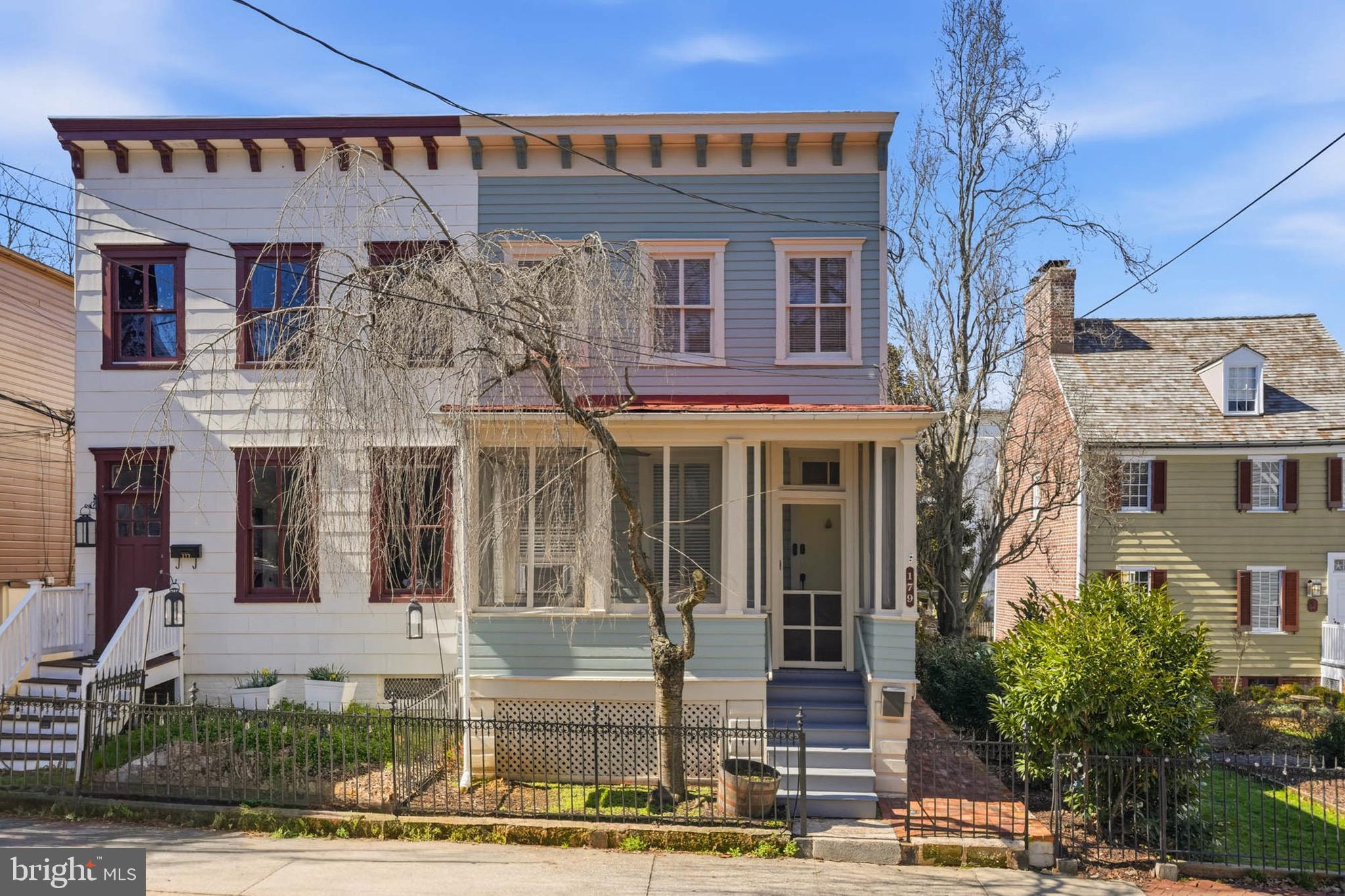 Welcome to the heart of downtown Annapolis at 179 Green Street. This charming home blends timeless character with modern comfort, this is just a block from Main Street and City Dock, few block from the Naval Academy, State Capitol building, boutique shopping, and Annapolis Elementary School. Located in one of the city’s most desirable neighborhoods, it offers exceptional walkability and vibrant city living. Move in ready with a new roof, new updated kitchen, new full bathroom on main floor, new plumbing, new electrical, new basement ceiling, and new fenced in yard. The main level features inviting front and enclosed side porches—perfect for morning coffee or unwinding with a glass of wine in the evening. Inside, wide-board pine floors lead to an updated L-shaped kitchen with bright white cabinetry, stainless steel appliances, and a convenient stackable washer and dryer nearby. The living room showcases rich wood wainscoting, detailed wood trim, custom built-in bookcases, and a rustic fireplace accent, creating a warm and cozy atmosphere. A dedicated dining room completes the main level, ideal for everyday living and entertaining. Upstairs, the home offers two spacious bedrooms and there is an extra versatile space ideal for a home office or nursery. A large bathroom showcases a Victorian-style Van Buren clawfoot tub,  new LVP flooring adding timeless historic character. Outdoors, the fenced backyard provides a private retreat for entertaining or relaxing. The property also includes two oversized off-street parking spaces, offering exceptional convenience that convey with the property. Step into a lifestyle steeped in history and culture. Wander charming cobblestone streets to acclaimed dining, embrace sailing and local events, and enjoy the dynamic rhythm of downtown living just beyond your doorstep. This is a rare opportunity to own a true piece of Annapolis charm. 
Fireplace non operational.