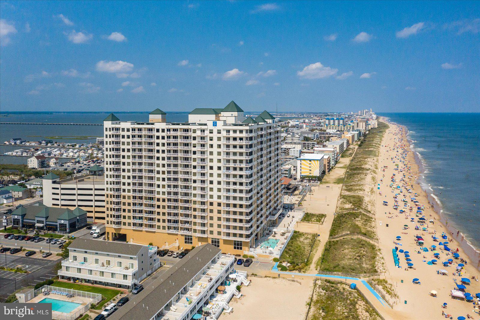 Experience life at the top of the luxurious Gateway Grand Residences in Ocean City, MD in Penthouse 1706.  This 4 bedroom 3 bathroom residence features incredible views of the Ocean, City Skyline, and Bay spanning for miles.  The huge picture windows showcase art in motion with the everchanging stunning scenery that makes up this barrier island.  From the gorgeous sunrises over the ocean to the magnificent sunsets you will find yourself constantly in awe of the natural scenery.  This residence is more than simply a luxury condominium at the beach, but rather a true experience for you and your guests.  Every room in the property shares similar views of water, sky, and wildlife.  A wrap around balcony can be accessed from the living room, dining room and guest bedroom, while a private balcony extends from the primary bedroom.  Each allowing the occupants the opportunity to step into the scenery.  Suspended 17 stories into the sky providing a prospective of Ocean City you did not know existed.  The living room and primary bedroom both have vaulted 2 story ceilings with additional windows only found on the Penthouse level of the Gateway Grand.  These windows bring the sky and clouds indoors adding to the ambiance.  The great room includes a chef's dream kitchen with upgraded commercial grade appliances, white cabinets, and granite countertops.  The kitchen has two seating areas for guests to choose from either at the elevated bar or the counter level island.  The island includes a beverage center convenient for when entertaining guests.  The dining room allows for a large dining table to accommodate your entire family.  Moving into the living room you will notice an abundance of seating and a fireplace with flush mounted TV above.  Custom Millwork accents the hallways leading to all 3 guest bedrooms and the primary suite.  This residence features 2 zones of water source heat pumps that allow from comfort year-round.  One zone services the bedrooms and bathrooms with a thermostat located in the primary suite, while the additional zone services the great room through a thermostat located in the living room.  These efficient HVAC's can be maintained by the in-house maintenance team through subscription and run off hot and cold water produced on the ground level of the building and funded by the condominium fee.  This residence was furnished and designed by a fabulous local interior designer and delivers to the new owner turn-key available for immediate occupancy.  The floors throughout the hallway and great room are a 12x24 porcelain tile while the bedrooms are carpeted.  The primary bathroom includes marble tile on the floors and walls including a whirlpool bathtub, custom tile shower, and dual sink vanity with granite tops.  This residence also includes a large, deeded storage locker #108 on Mezzanine Level.  Building amenities include heated indoor and outdoor pools, 24/7 fitness center, kid's club room, multiple owner's lounges, a grand lobby with staffed desk, security in the evenings, secure FOB access, and parking garage with 3 spaces and electric car chargers available.  A truly once in a lifetime opportunity to own the Southeast corner Penthouse located in one of the Ocean City's most luxurious buildings awaits.  Reach out for your private tour of this impressive residence today!
