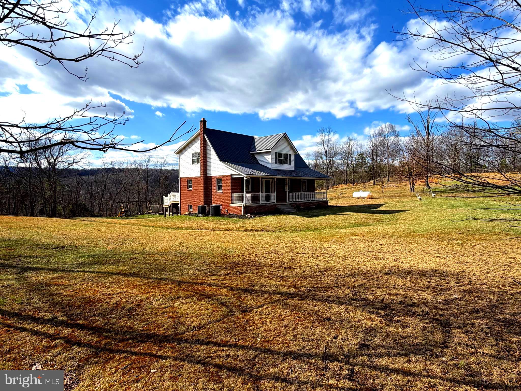 Spacious and serene, this beautiful 4-bedroom, 3.5-bath home sits on just over 25 unrestricted acres, offering privacy, comfort, and stunning mountain views. Relax and take in the scenery from the large front porch, or entertain guests on the expansive back deck and patio.

Inside, you’ll find hardwood floors and all-new flooring throughout, along with a thoughtfully designed layout featuring a primary suite with ensuite bath on the main level. The home is move-in ready with appliances conveying, including a brand-new dishwasher, as well as new window blinds for a fresh, modern touch.

Enjoy year-round comfort with two new HVAC units, and take advantage of additional living space in the basement family room—perfect for gatherings, a home theater, or recreation. A one-car garage adds convenience, while the expansive acreage provides endless possibilities with no restrictions.

This property offers the perfect blend of peaceful country living and modern updates—don’t miss your chance to make it yours!