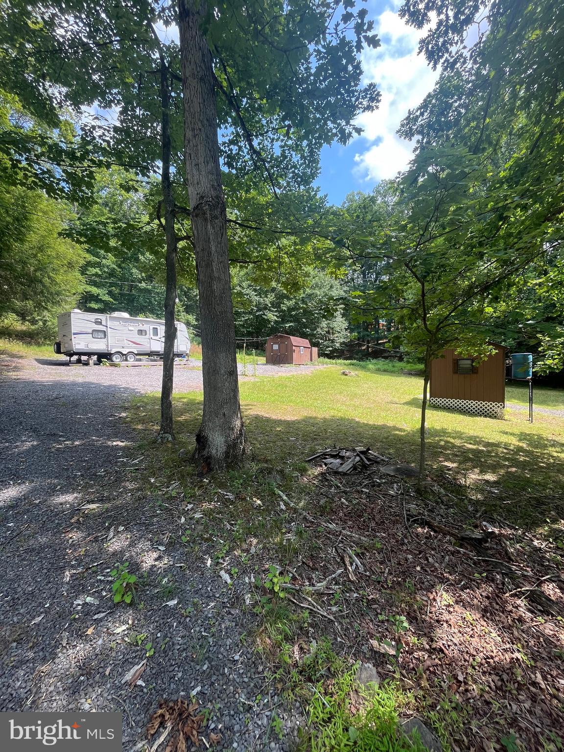 Discover the possibilities with this remarkable 2.19-acre partially cleared lot, ready for your vision. The property already features a well, septic system, and electricity, making it an excellent choice for a weekend getaway, future home, or dream cabin. Currently used as a camping retreat, the camper is negotiable with the sale, offering an opportunity to start enjoying the property right away. Surrounded by mature trees and abundant wildlife, you'll appreciate the peace, privacy, and natural beauty this setting provides. Just a short distance away, enjoy access to the scenic Cacapon River, where you can spend your days floating the river, fishing, kayaking, or simply relaxing while listening to the soothing sounds of the rapids. Whether you're looking for a recreational escape, a permanent residence, or the perfect location to build your dream cabin, this property offers the ideal blend of convenience, tranquility, and outdoor adventure.
