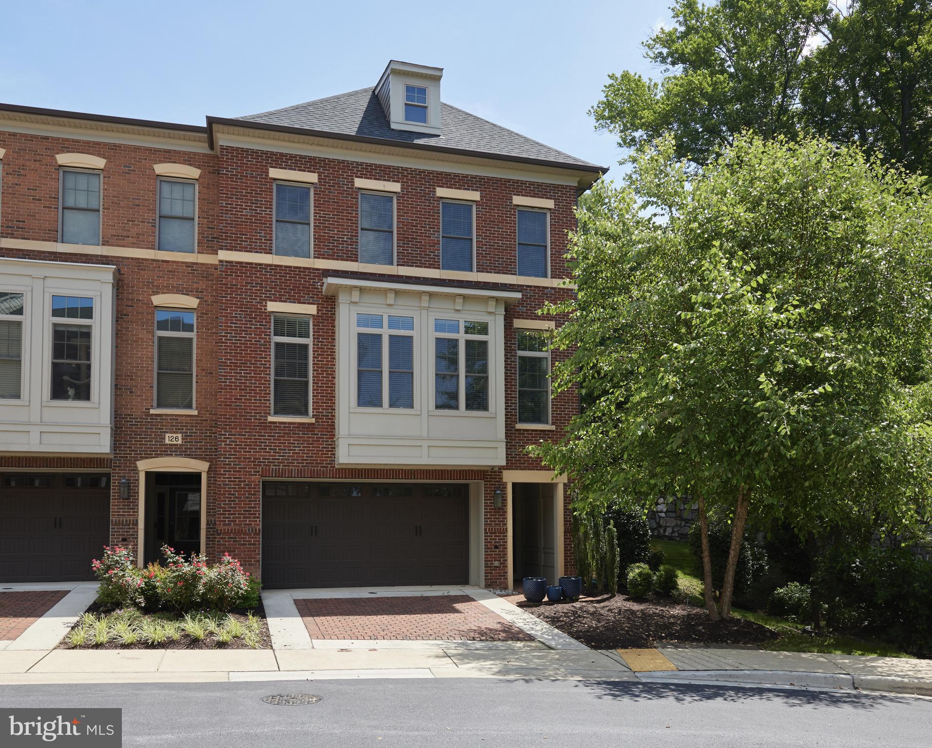 WELCOME TO A RARE AND REFINED ELEVATOR TOWNHOME OFFERING IN THE PRESTIGIOUS POTOMAC HIGHLANDS COMMUNITY!!!......Built in 2017 and proudly maintained by its original owners, this exquisite four-bedroom, three-and-a-half-bath end-unit townhome was the original model residence, thoughtfully designed for elevated living and maximum privacy. Spanning three luxurious levels and serviced by a private in-home elevator, this home combines sophisticated style with exceptional functionality.....Inside, solid hardwood floors flow throughout, complemented by soaring 9'+ ceilings, custom crown molding, and elegant coffered ceilings....The main level boasts a formal dining room, an expansive living area with seamless access to a private outdoor patio, and a gourmet kitchen equipped with top-tier stainless steel appliances, a walk-in pantry, a large center island, and a classic butler’s pantry, ideal for both daily living and gracious entertaining......The upper level features a truly grand primary suite with a private sitting area, two oversized walk-in closets, and a spa-inspired en-suite bath with a soaking tub overlooking treetop privacy, a dual-entry shower, and dual vanities. Three additional bedrooms and ample closet space provide comfort for family or guests......Additional highlights include a spacious two-car garage, recessed lighting, solid-core doors, and abundant storage throughout. As an end-unit, the home enjoys enhanced natural light and a unique sense of seclusion rarely found in townhome living.....Perfectly situated just minutes from Cabin John Village, award-winning schools, walking and hiking trails, fine dining, boutique shopping, and with easy access to I-270, I-495, and downtown Bethesda, this home offers both tranquility and unbeatable convenience..128 BYTHAM RIDGE LANE IS MORE THAN A RESIDENCE, IT IS A STATEMENT OF ELEGANCE, ACCESS, AND TIMELESS POTOMAC LIVING! THIS IS A MUST-SEE!!