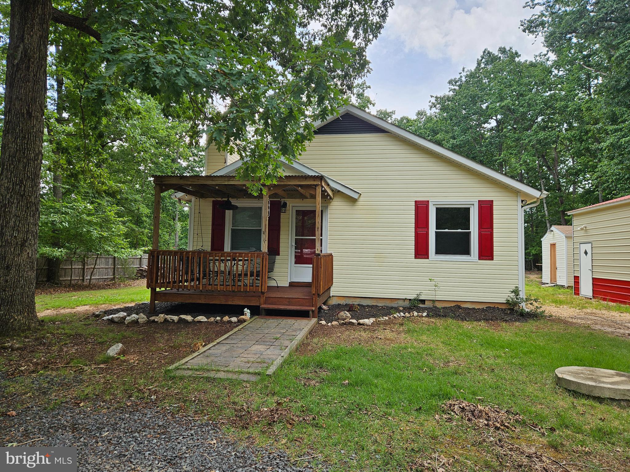 Welcome to 15012 Comfort Lane!  Sitting on  1.43 acres, this cute water access home is the perfect lake getaway.  Don't let the square footage fool you.  This house offers lots of space.  

Enter  the house through the front door under the covered front porch into the living room.  A great line of sight to the back of the house.  The living room has a fireplace to enjoy for the cooler days to come.  There is a coat closet tucked behind the front door.  The living room is open to and  flows into the dining area which is open to the kitchen.  The kitchen offers lots of counter space and plenty of cabinets.  The back door off the kitchen leads out to the back porch which is also covered.

Back inside the two bedrooms are down the hallway, one in each direction.  Each bedroom accomodates a queen size bed and  additional furniture.  Each room has a good size closet.   There are two additional closets in the hall.  One for linnen.  The other for storage of any kind.  The bathroom is near the bedrooms.  It has a tub shower combination and is  large enough to house the washer and dryer. 

Outside to the 20x40 metal garage with roll up door.  The garage has electricity.  It offers plenty of room to store your boat, mower, cars, or just about anything.  Right next to the garage is a shed which also has electricty.  Are you looking for a workshop?  The shed is the answer.   Attached to the shed is an out door shower.

The neighborhood common area is just around the corner.  There is a boat launch for easy access to the lake.  Boat all day and take your boat home to keep it n the garage.  Spend time in the community pavilion or on the volleyball court.

Don't miss out on this great property and don't be fooled by the square footage.  This home is laid out well and with the addition of the garage there is plenty of room!  This house is a great way to get started with a lake home and plenty of room to expand down the road.