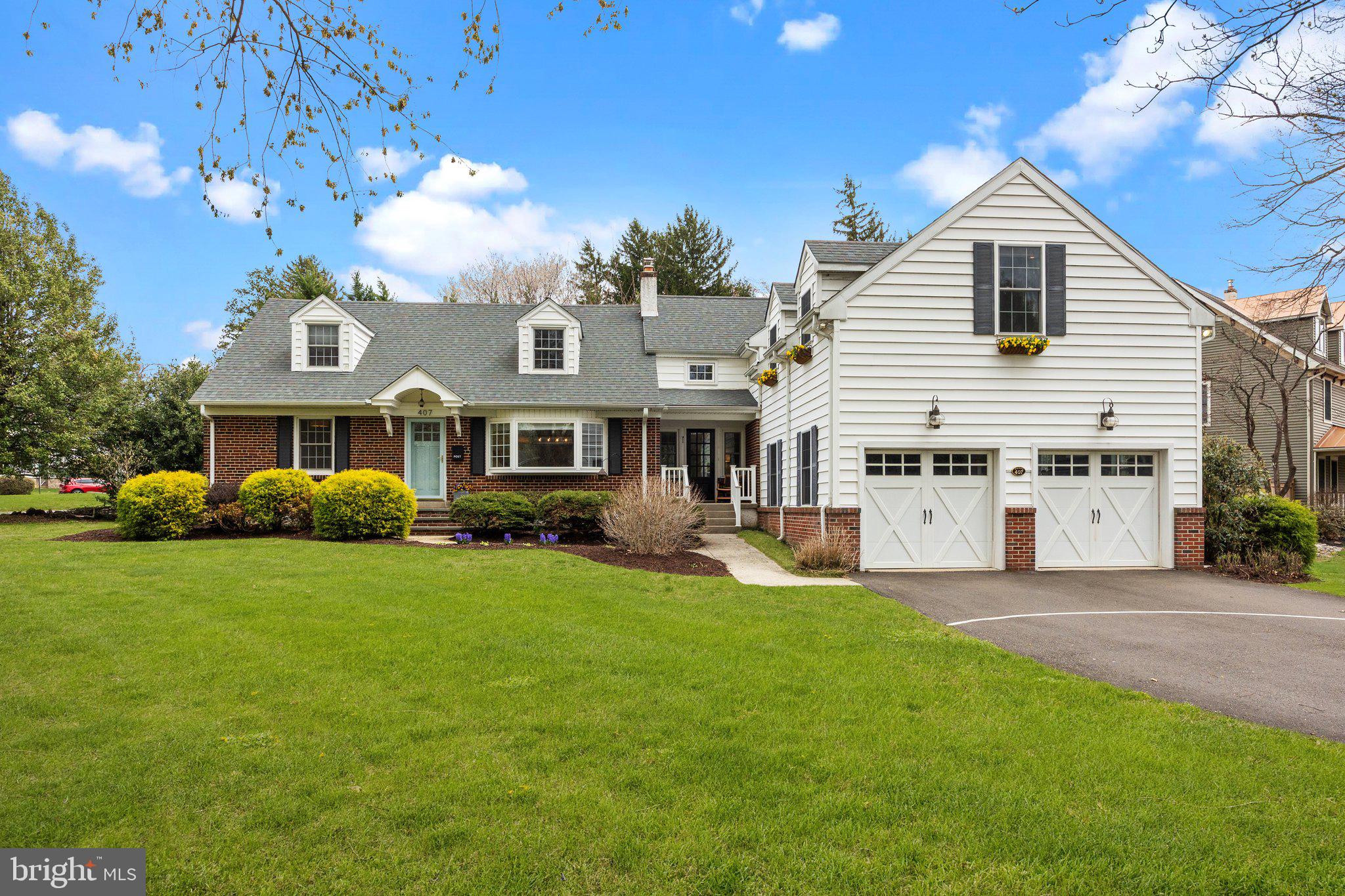 Don't miss this expanded Cape Cod style home, brimming with charm, and offering an abundance of space to accommodate today’s lifestyle. Perfectly situated in Historic Newtown Borough, this residence is just a short stroll from quaint boutiques, acclaimed restaurants, the wonderful Newtown Theatre and community parks. 
Sunlight pours through every window, highlighting the rich hardwood floors and showcasing lovely views of mature trees and vibrant gardens. At the heart of the home lies the thoughtfully updated kitchen featuring custom white cabinetry, elegant soapstone countertops and farm sink, stainless steel appliances, and stylish pendant lighting. Just off the kitchen, the inviting family room is anchored by a cozy gas fireplace flanked by a wood mantle, and custom built-in shelving to display your books, art and cherished keepsakes. The spacious dining room, enhanced by a wide bay window, provides a perfect setting for gatherings both large and small.
A convenient main floor bedroom, with a generous walk-in closet, is adjacent to a full bath—an ideal space for guests or multi-generational living. A private home office rounds out this level, offering a quiet retreat for remote work or creative pursuits. A spacious two car garage, accessed via the mudroom, offers plenty of room for outdoor gear and equipment.
On the second level, the expansive primary suite features a walk-in closet and beautifully updated en-suite boasting luxurious custom tile finishes, a large walk-in shower and dual-sink vanity. Three additional well-proportioned bedrooms and hall bath are included on this level, in addition to a dedicated laundry room and charming alcoves offering flexible space for reading, workouts, and hobbies. 
The partially finished lower level is designed for fun and function, offering spaces for, media, music, and recreation, along with a separate area for workshop and storage. Step outside to your private stone patio—perfect for sipping your morning coffee, hosting a summer BBQ, or enjoying lawn games as the sun begins to set. Impeccably maintained and move-in ready, this exceptional home invites you to enjoy the best of Bucks County living in one of its most picturesque towns. Conveniently located close to major highways, train stations, and airports for your next vacation getaway!