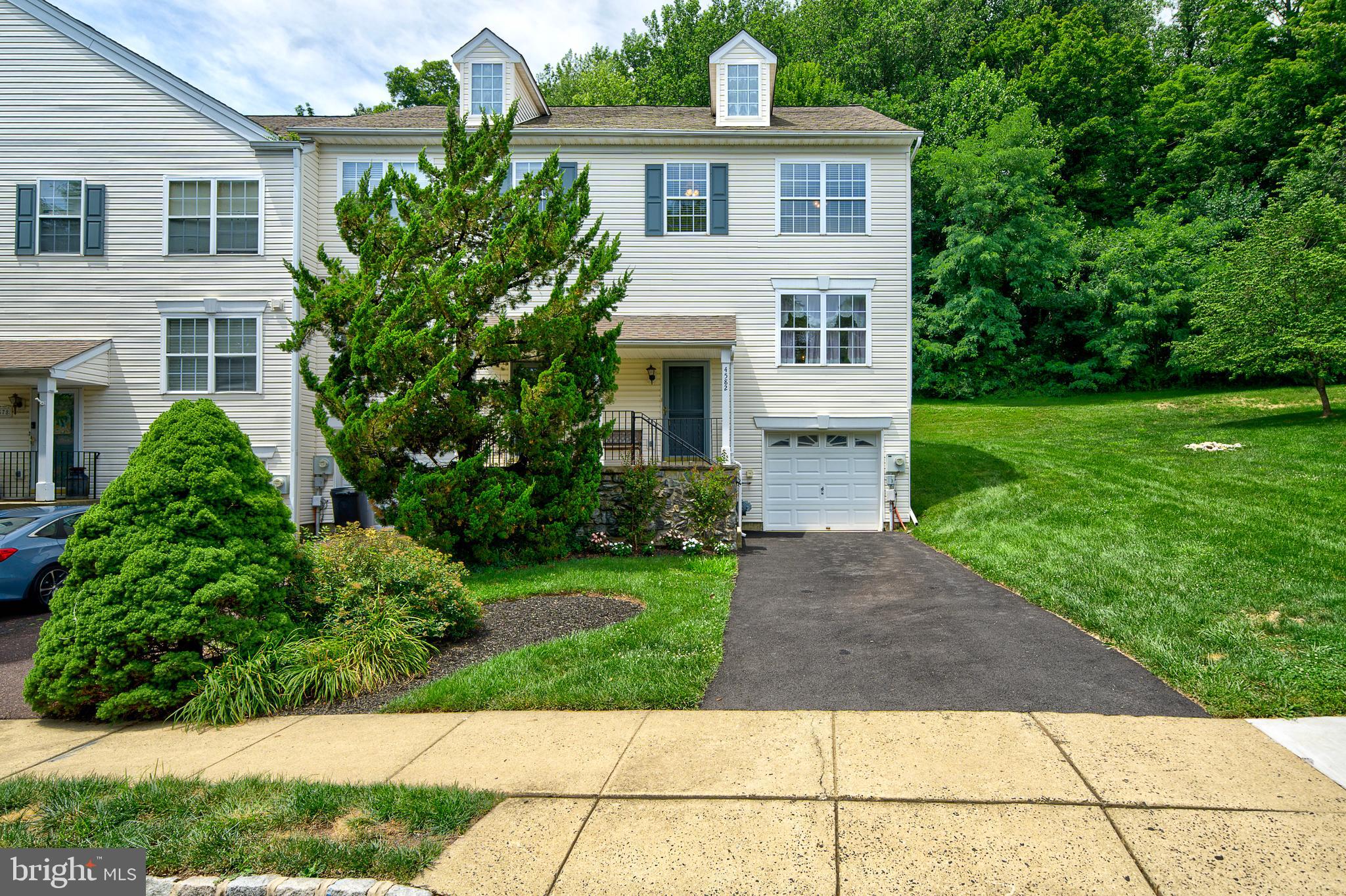 Fantastic END UNIT townhome in a prime location at the back of the community in Patriots Ridge backing to woods, this home features three bedrooms, two and a half baths, a long driveway to an oversized garage, and full basement. Mr. & Mrs. Clean live here! Lovingly maintained and updated by the original owners, the beautifully updated kitchen boasts modern white cabinets with subway tile backsplash with a designer herringbone insert, updated stainless steel appliances and sleek countertops. The spacious dining room has newer flooring and is filled with natural light from double windows and a large double closet. The flooring continues to the open living room which extends to the rear deck via sliding glass doors, where serene wooded views create a peaceful private retreat with plenty of space to barbeque and entertain. A convenient, updated powder room is centrally located on this level. Upstairs, the primary bedroom features newer flooring, dual walk in closets, ceiling fan, and an updated full bathroom. Two additional spacious light filled bedrooms are located here. The hall bathroom has been refreshed giving the space a clean, fresh, and modern feel. Down to the lower level, you will find a dedicated laundry room with tons of storage shelves and convenient access to the garage. If you are looking for additional living space, the clean-as-a-whistle basement, great for storage, currently being used as a workshop, offers an easy opportunity to finish and create a home office, gym, or movie and recreation room. New HVAC in 2022.The low association fee covers lawn care, trash removal, and maintenance of common areas, providing truly carefree living. Ideally located just minutes from downtown Doylestown Borough, Peace Valley Park, major highways, and within the Central Bucks School District. This home delivers the perfect balance of comfort, convenience, and effortless living... Showings begin on Sunday 7/19 at the open house.