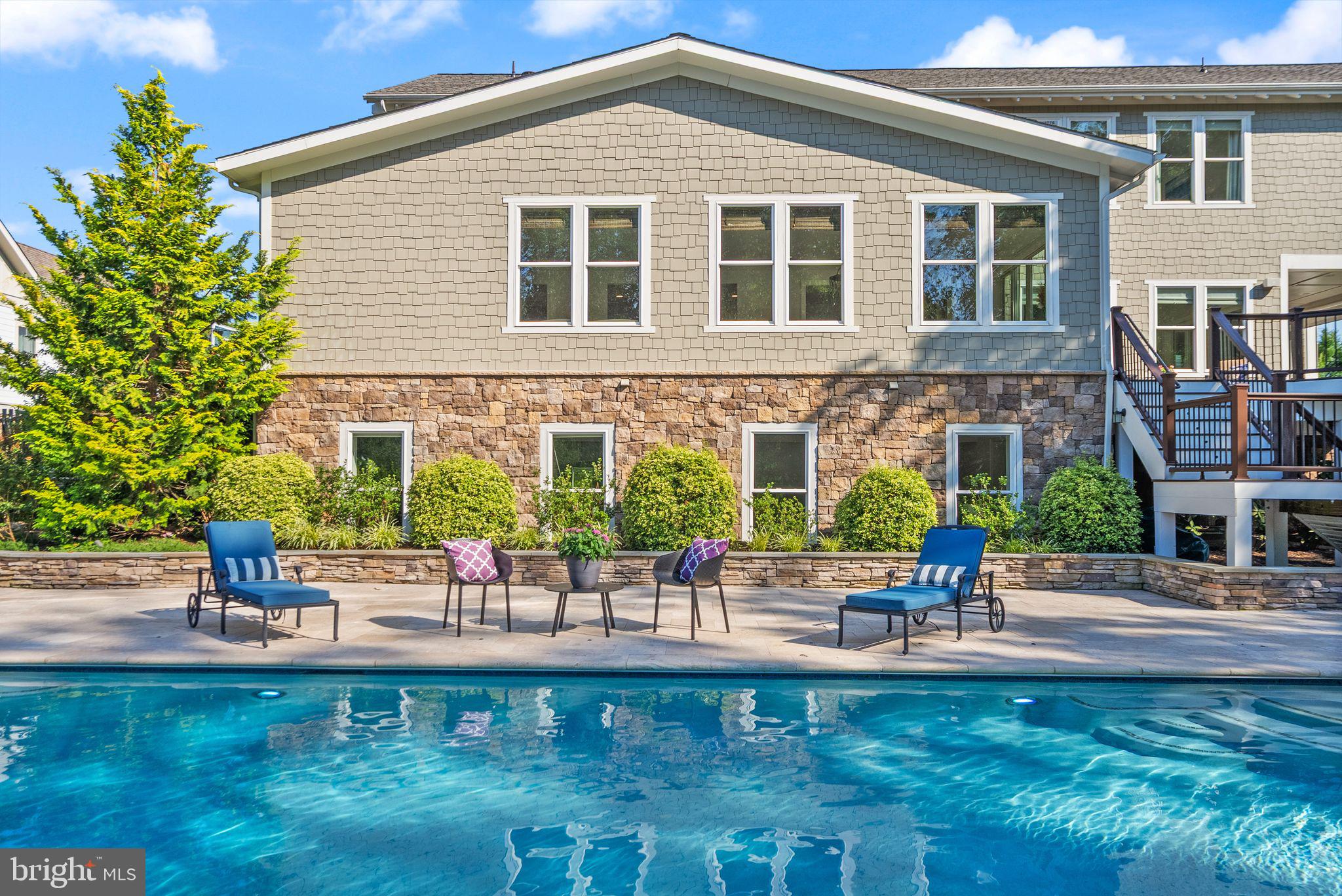 A Quietly Grand Retreat in The Grant at Willowsford in Ashburn, VA.

Set within the coveted Grant at Willowsford, this exceptional Arcadia Model offers a rare blend of scale, craftsmanship, and serenity. With over 7,000 square feet of thoughtfully designed living space, the home feels expansive yet deeply welcoming—luxury here is felt in comfort, light, and intention.

From the moment you enter, soaring 10-foot ceilings and abundant natural light create an immediate sense of calm and openness. Newly installed flooring runs throughout the home, adding warmth and cohesion while grounding each space in a refined, organic aesthetic. Every level flows seamlessly, designed for both everyday living and meaningful gatherings.

The upper level features four generously sized bedrooms and three full baths, offering privacy and ease for family and guests alike. The primary suite is a true sanctuary—peaceful, expansive, and quietly elegant. Its spa-inspired bath invites relaxation with a deep soaking tub, glass-enclosed walk-in shower, and beautifully curated tilework, creating a space where mornings feel unrushed and evenings unwind naturally.

A light-filled loft on the upper level offers a versatile retreat—perfect for movie nights, creative pursuits, or cozy family moments. Designed to adapt, it becomes whatever life needs it to be.

At the heart of the home, the chef’s kitchen  blends performance with beauty. Equipped with Wolf and Viking appliances, it’s equally suited for everyday meals and effortless entertaining. This is a space designed for connection—where cooking, gathering, and conversation happen organically.

Step outside to a private backyard that feels worlds away. A custom-designed swimming pool and spa create a resort-like atmosphere, while mature trees and professional landscaping provide rare privacy and a sense of escape. It’s an outdoor setting meant for slow mornings, summer evenings, and restorative quiet.

The finished basement continues the home’s open, airy feel with 10-foot ceilings and expansive living areas. Whether envisioned as a media lounge, fitness studio, guest retreat, or entertaining space, it offers flexibility without compromise.

Thoughtful Luxury, Now and Into the Future.

The home is elevator-ready, allowing for future convenience while maintaining clean lines and timeless design.

Backing to protected woodlands, the setting is peaceful and picturesque, yet moments from the conveniences of Ashburn. Residents of Willowsford enjoy access to an award-winning lifestyle, including scenic trails, community events, farm-to-table experiences, and a deep connection to nature.

This is luxury that feels grounded, intentional, and enduring.
A home where space, design, and lifestyle come together—beautifully and effortlessly.
*Move-in Ready -  The house has an elevator shaft ready to have an elevator installed. *