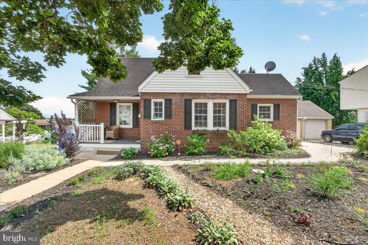 Welcome to your own storybook home, where timeless charm meets beautifully landscaped grounds on nearly one-third of an acre. Surrounded by mature shade trees, colorful perennial gardens, and inviting outdoor spaces, this charming 4-bedroom, 2-bath brick Cape Cod offers the perfect blend of character and thoughtful updates. 

Inside, gleaming hardwood floors, fresh paint, and an open, welcoming floor plan create a warm and inviting atmosphere. The beautifully updated kitchen features custom sage green cabinetry, stainless steel appliances, a brand-new dishwasher, granite countertops, and an open-concept design that flows seamlessly into the dining and living areas, perfect for both everyday living and entertaining.

The living room is the heart of the home, showcasing a stunning custom built-in library with window seating and an electric fireplace, creating the perfect place to curl up with a good book or gather with family and friends.

Step outside to your own private backyard retreat, complete with a pergola-covered patio, built-in fire pit, raised garden beds, mature trees, and a detached storage shed. Whether you're hosting summer cookouts, tending to the gardens, or simply relaxing under the shade, this outdoor space was designed to be enjoyed year-round. The thoughtfully designed gardens feature a beautiful mix of native and ornamental plantings, including hydrangeas, bee balm, spotted Joe Pye weed, echinacea, hostas, roses, yarrow, goldenrod, mountain mint, lamb's ear, passion flower vine, and seasonal blooms that create year-round color while attracting butterflies, hummingbirds, and other pollinators. Raised garden beds are ready for your homegrown herbs and vegetables and already include rosemary, basil, oregano, thyme, tomatoes, squash, broccoli, and brussels sprouts.

Recent updates include a new high-efficiency heat pump system offering energy-efficient heating and cooling, a 2022 hot water heater, and a brand-new dishwasher, providing peace of mind for years to come.

Conveniently located near I-70, I-81, and US-40, this home offers easy access for commuters while placing you just minutes from everything Hagerstown has to offer. Spend weekends exploring Hagerstown City Park with its scenic walking paths, lakes, playgrounds, paddle boats, and the Washington County Museum of Fine Arts. Nearby Fairgrounds Park and Doub's Woods Park provide even more opportunities for outdoor recreation. Downtown Hagerstown continues to flourish with locally owned restaurants, breweries, boutiques, and charming coffee shops like Cannon Coffee and Next Chapter Café & Bookshop. Enjoy dinner at favorites like Broad Axe and Rik's Café, catch a performance at The Maryland Theatre, or cheer on the Flying Boxcars at Meritus Park.

Offering timeless character, modern updates, exceptional outdoor living, and a location close to parks, dining, shopping, entertainment, and major commuter routes, 843 Jefferson Boulevard is the perfect place to call home.

Schedule your tour today!

*Please note that Ring security cameras are installed on the property.