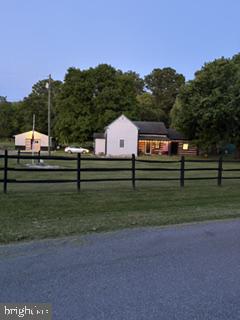 Professional photos and drone photos will be updated 6/3 
Here it is — the one everyone’s been waiting for! This rare Jefferson County find welcomes you, your lifestyle, and all of your furry friends on move‑in day. Nestled on an expansive 18-acre unrestricted property, this traditional 1945 log home combination blends rustic charm with simple, peaceful living. Lovingly maintained, it offers the perfect retreat for anyone seeking privacy, tranquility, and sweeping pastoral views.
Step inside to a warm, inviting interior where the combined living and dining area serves as the heart of the home. Rich wood floors, stone accents, and a cozy fireplace with wood‑burning stove create an atmosphere that feels timeless and comforting. The home features two spacious bedrooms, two full baths, an efficient kitchen with essential appliances, and the convenience of upper‑level laundry for easy everyday living.
For equestrian lovers, this property is a dream come true. Bring your horses — they’re welcome here. Enjoy a paddock, 8‑stall barn with wash bay, run‑in shed, eurociser, and an attached living space ready to be brought back to life. The lush green back pasture is tree‑lined and backs to a sod farm, offering beauty, privacy, and room to roam.
With potential for subdivision, the opportunities are endless — multigenerational homesteading, investment, or creating a family compound. Buyers are encouraged to perform due diligence. The cleared lot, fenced perimeter, detached garage, and ample driveway parking add to the ease of country living.
Relax on the porch or patio and soak in the peaceful surroundings, free from through‑traffic thanks to quiet Willingham Road. All of this while being conveniently located near historic downtown Charles Town, Harpers Ferry, the MARC train, and commuter routes to MD, VA, and DC.
Experience a lifestyle where simplicity meets nature and every day feels like a retreat. Don’t miss your chance to own this exceptional property offering comfort, freedom, and adventure.