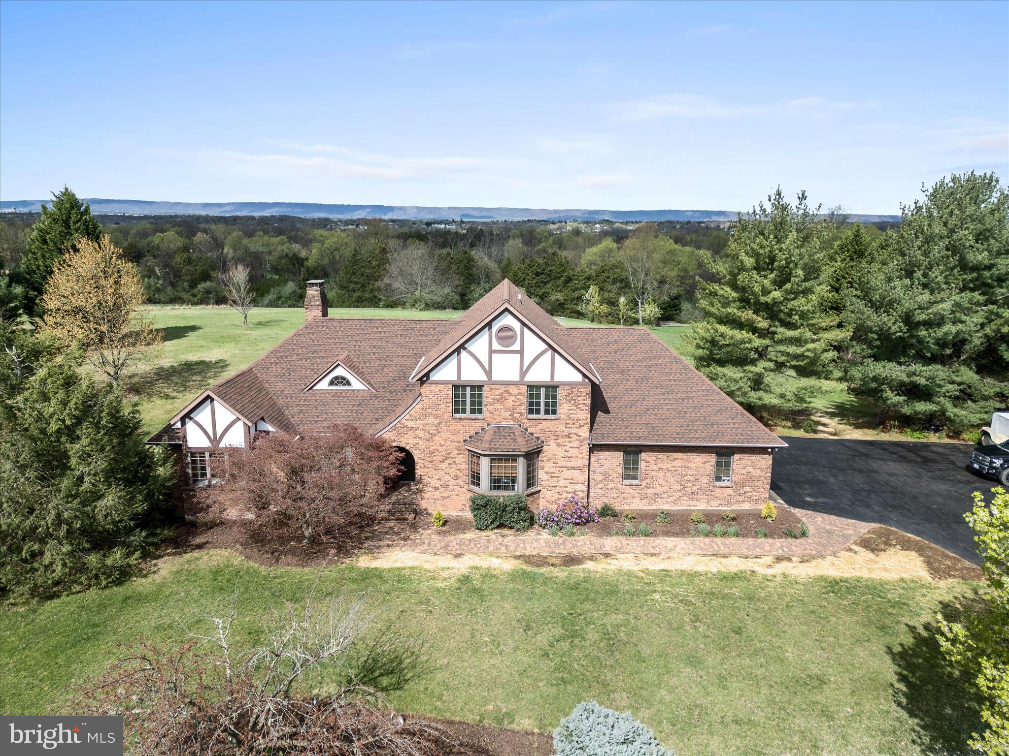 **Charming English Tudor Home on Over 5 Acres in Meadow Springs Farm**
Welcome to your dream retreat! This stunning 3-bedroom, 2.5-bathroom English Tudor home offers over 4,000 square feet of finished living space, nestled on an expansive 5+ acre lot in the desirable Meadow Springs Farm community. As you approach the property, you'll be greeted by a picturesque driveway lined with chestnut trees, setting the tone for the beautiful landscape.

The main level features a primary suite with a small cedar-lined closet and a spa-like bathroom that includes heated flooring—perfect for relaxation and comfort. The heart of the home boasts exquisite Bellawood Patagonian Rosewood flooring, backed by a 100-year warranty, complemented by updated wood stoves on both the main level and in the basement, providing warmth and charm throughout.
Enjoy cozy evenings in the inviting library, which includes built-in shelving, or bask in natural light in the sunroom. For those who love to entertain, the home features a well-designed layout that enhances the experience.
Practical amenities abound, including a 1-year-old HVAC system, additional mini-splits in the insulated garage, a roof that is 7 years old, and new insulation for improved energy efficiency. The home is also equipped with an updated water purification system, central vacuum, updated window seals, a sump pump, and radon mitigation, ensuring worry-free living. The basement has an additional cedar lined closet as well as plumbing rough-ins, making it easy to expand this space Additionally, the sauna in conveys.
The property features an oversized 3-car insulated garage with two mini-splits, a workstation, and a Tesla charger, along with an extra 2-car detached garage, providing ample storage for vehicles, recreational equipment, or hobbies.
Outside, the expansive grounds are perfect for those looking to embrace a rural lifestyle, with plenty of room for horses and chickens. With Rain Guard gutters for added peace of mind, this property truly has it all.
With so many updates and features to discover, be sure to consult the documents for a full list of improvements. Don’t miss your chance to call this remarkable property home! Schedule a showing today and experience its charm and elegance for yourself! NO SIGN ON PROPERTY! Sellers are packing.