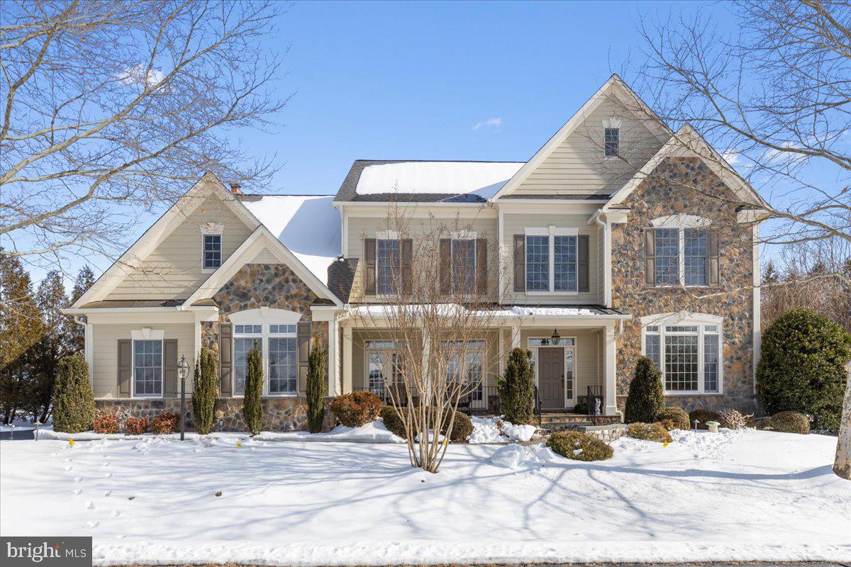 This exceptional estate offers over 8,100 square feet of refined living space on a private homesite surrounded by mature trees and a protected conservancy, ensuring permanent privacy. Designed with a stone-front entrance and durable HardiePlank siding, which was recently repainted for long-term, low-maintenance living. This residence showcases 4 expansive en suite bedrooms, 5 full baths, 1 half bath, a fully finished walkout stairs basement, and a 3-car garage, complemented by a 6-car driveway. A main-level mudroom with 2 closets and a tub was conveniently placed by the garage entrance to the home. Impressive outdoor living features curated lighting, custom flagstone walkways, a covered lighted front porch, screened-in back porch, stone back patio, with a large stone fireplace; all create a serene, retreat-like atmosphere.

Entering your new home, a grand marble floor 2-story foyer, with Schonbek crystal chandeliers, wrought iron balusters, sets an elegant tone, seamlessly transitioning to gleaming hardwood floors across the main level. 10-foot tray and coffered ceilings, alcove niches with accent lighting, and custom millwork elevate the architectural presence throughout the home. Formal living and dining rooms offer refined gathering spaces, while the large private office features built-ins, ideal for working from home. The inviting family room is equipped with a built-in 7.1 wired for surround sound system, for an immersive audio experience. This room also features a coffered ceiling, stone fireplace, and dual French doors, leading to the screened-in porch. Andersen windows with high-end tinted solar films fill the home with natural light, while custom-designed draperies and height-adjustable cordless shades offer comfort and privacy.

At the heart of the home, the chef’s kitchen offers a large walk-in pantry, expansive island, five-burner cooktop, dual dishwashers, a wet bar, and Bosch and Whirlpool appliances. A sunrise sunroom off the breakfast nook boasts large sun-filled windows and offers a pleasant sight through French doors that flow onto the stone patio. 

The luxurious owner’s suite includes a gas fireplace, tray ceiling, coffee bar, sitting area, and a spa-inspired bath with seamless glass shower, a separate custom-built-in dressing vanity, double sinks, a large tub, plantation shutters, and an impressive walk-in closet designed for two. All secondary bedrooms feature walk-in closets, with soundproof walls throughout all bedrooms and bathrooms, including the half bath for added privacy.

The upper-level laundry room and a large linen closet add everyday convenience. The fully finished walkout basement includes a large flexible den with two large closets (optional 5th bedroom), two large enclosed bonus rooms, a recreation and fitness area, and a cozy TV enclave area with a gas fireplace, for entertainment, and large French doors to the exterior.

Meticulously maintained, the home includes a new roof, new furnace, new AC units, new water heater, and oversized 6-inch gutters. Ideally located just minutes from thriving downtown Leesburg, offering easy access to shopping, dining, and major thoroughfares, including Routes 7, 15, and the Dulles Greenway. Welcome Home!