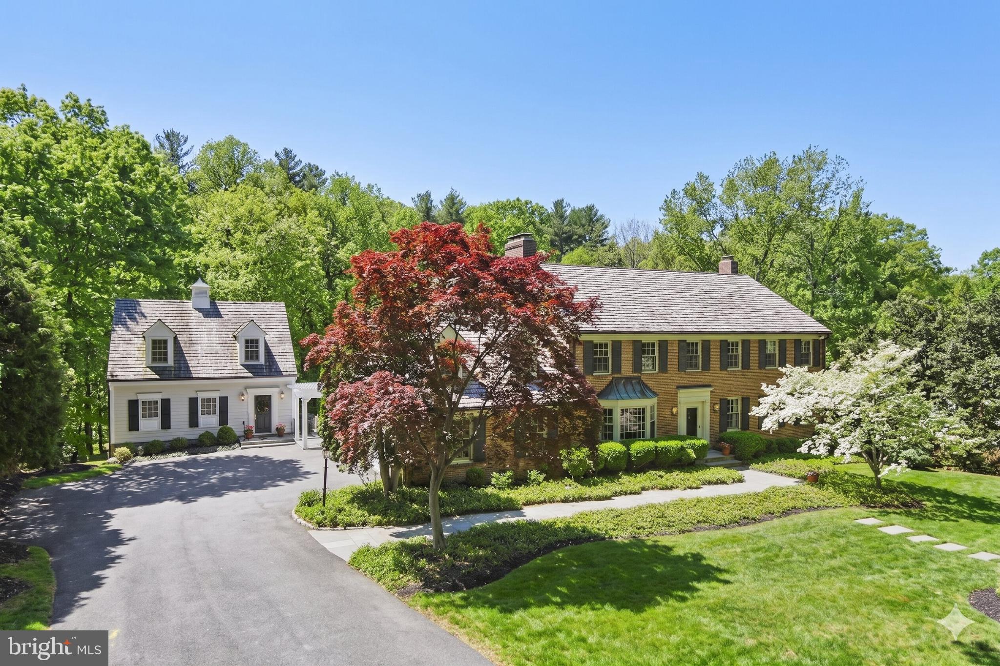 Set on over two exquisitely landscaped acres backing to a serene, park-like oasis, this exceptional one-owner estate is framed by dramatic hardscape and thoughtfully designed outdoor living spaces—creating a truly spectacular setting for refined entertaining. Tucked within an intimate cul-de-sac of distinguished homes, it offers a rare sense of privacy, beauty, and presence.

A grand entry introduces elegant formal rooms, including a gracious living room and an expansive dining room, all centered around a classic center hall staircase that establishes a tone of timeless sophistication.

The updated eat-in kitchen blends style and function, opening seamlessly to a wisteria-draped dining terrace with ironwood decking. Here, sweeping views and natural surroundings create an idyllic backdrop for both intimate gatherings and everyday living.

Designed with both comfort and architectural character in mind, the home features a sun-filled solarium, multiple stately fireplaces, balconies with wrought-iron railings, a richly appointed wood-paneled great room with wet bar, and a refined private library. A discreetly positioned, oversized two-car side-load garage enhances both convenience and curb appeal.

The upper level is anchored by an expansive owner’s suite and complemented by four additional well-proportioned bedrooms and three full baths, along with a versatile bonus space ideal for a private office or quiet retreat.

The fully finished walk-out lower level offers exceptional versatility—featuring a spacious recreation room ideal for billiards and movie nights, a second office, an additional bedroom and full bath, generous storage, and direct access to a private patio framed by elegant archways. Bathed in natural light from its southern exposure, the space feels warm, open, and inviting.

A truly extraordinary offering, the separate Maisonette spans approximately 2,100 square feet across three finished levels. Complete with a bedroom, full bath, fireplace, kitchenette, and washer/dryer hookup, it provides remarkable flexibility as a guest residence, in-law suite, private office, or creative studio.

Enhancing both comfort and quality, the main residence features custom replacement windows by Pella, along with a propane-fired whole-house generator for peace of mind year-round.

Perfectly positioned in close-in Potomac, just moments from the charm of Potomac Village, the scenic paths of the Chesapeake and Ohio Canal, and the natural beauty of Great Falls Park, with convenient access to Washington, DC and Northern Virginia—this estate seamlessly blends timeless elegance, modern comfort, and an exceptional lifestyle.