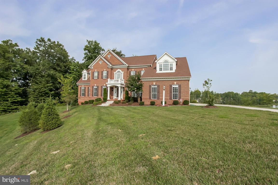 Be the envy of the neighborhood with the best view in the community. This home overlooks the length of the lake and the golf course. Why wait for a  home to be built, when this one is ready to go and has EVERY upgrade except the elevator. The seller spared no expense w/ a state of the art theater room, 10 feet ceilings in the basement, Smart House wiring, and lots of built in bookshelves.