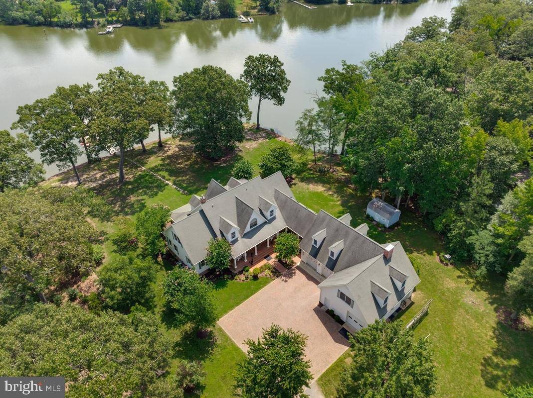 Beautiful Southern Maryland Coastal Retreat. Gracious and sophisticated. Elegant details throughout this incredibly, well-appointed home.  Custom  barrel ceiling and stained glass make a beautiful  statement in the grand entry foyer.  Inviting Family Room with serene water views. Newly renovated gourmet chef's kitchen is a coastal lovers dream. Enjoy sub-zero Wolf and Cove stainless appliances throughout. Custom white Cabinets and a blueberry hued Island grace this light and bright kitchen. Creamy quartz counter-tops and backsplash w/ Kohler ceramic and cast-iron sinks. Custom lighting and hardware.  So very pretty with island seating and prep sink, all with water views. Kitchen and casual dining access to the large waterside screened porch for that morning coffee or evening dinner. Enjoy the walk-in pantry and open sight lines from the kitchen through the casual dining spaces and into the expansive Family Room. Warm Brazilian Cherry hardwood flooring flows through most of this spectacular home.  Stunning water and garden views abound. Formal Dining Room with Cherry Built-Ins and pretty French pocket doors. A newly remodeled cozy mud room w/ fireplace makes a fabulous drop-zone for family and friends.  Enjoy your Office library with cherry Built-Ins.  Main Floor Primary Suite Wing has dual renovated bathrooms complete with heated floors and steam shower. Dual walk-in closets. Relax in the Great Room with cherry built-ins, a gas fireplace and custom windows to optimize all the pretty water-views. Front and Back Deep Covered porches to enjoy Alfresco Dining, Entertaining and Peaceful Tranquility. Take the Elevator or stairs up to the 2nd floor for the additional 3 bedroom suites. Lovely  bonus Room upstairs for additional guests or a tucked away water view retreat. Custom arched doorways and rounded corners throughout. Niches and storage make this home so very special.  Basement has multiple rooms and  of course, MORE storage; a walk-in safe, a severe weather safety room,  exercise and hobby space, a half bath and more.   
4+ Car Garage is attached to the home via covered Breezeway. The entire space above the Garages is available for storage or expansion with upper access from the house via a gallery w/skylights or a wide staircase inside the garage. Pier is Large and has been expanded to include two lifts (20,000lb and 7,500lb) to meet all your boating and kayaking needs. Over 300' of shoreline on scenic Combs Creek (6-8' deep at  end of pier) and 5 minute boat ride to Breton Bay and the Potomac.  This home blends one-of-a-kind customized luxury with Southern Living Charm.  Located 5 minutes from the heart of Leonardtown you'll have all the privacy you could desire in your waterfront home yet still be close to area shopping and events. So much to love and see in this stunning custom home. Over 5900 finished sf above grade alone! Another 1720 sf is partially finished in the basement. The unfinished space above the garages is sub-floored and ready for your next expansion project. You will have room for everything and more. The perfect Retreat. 30 Minutes to NAS Patuxent River and 90 minutes to DC and VA. Appointment ONLY listing with prior notice required.