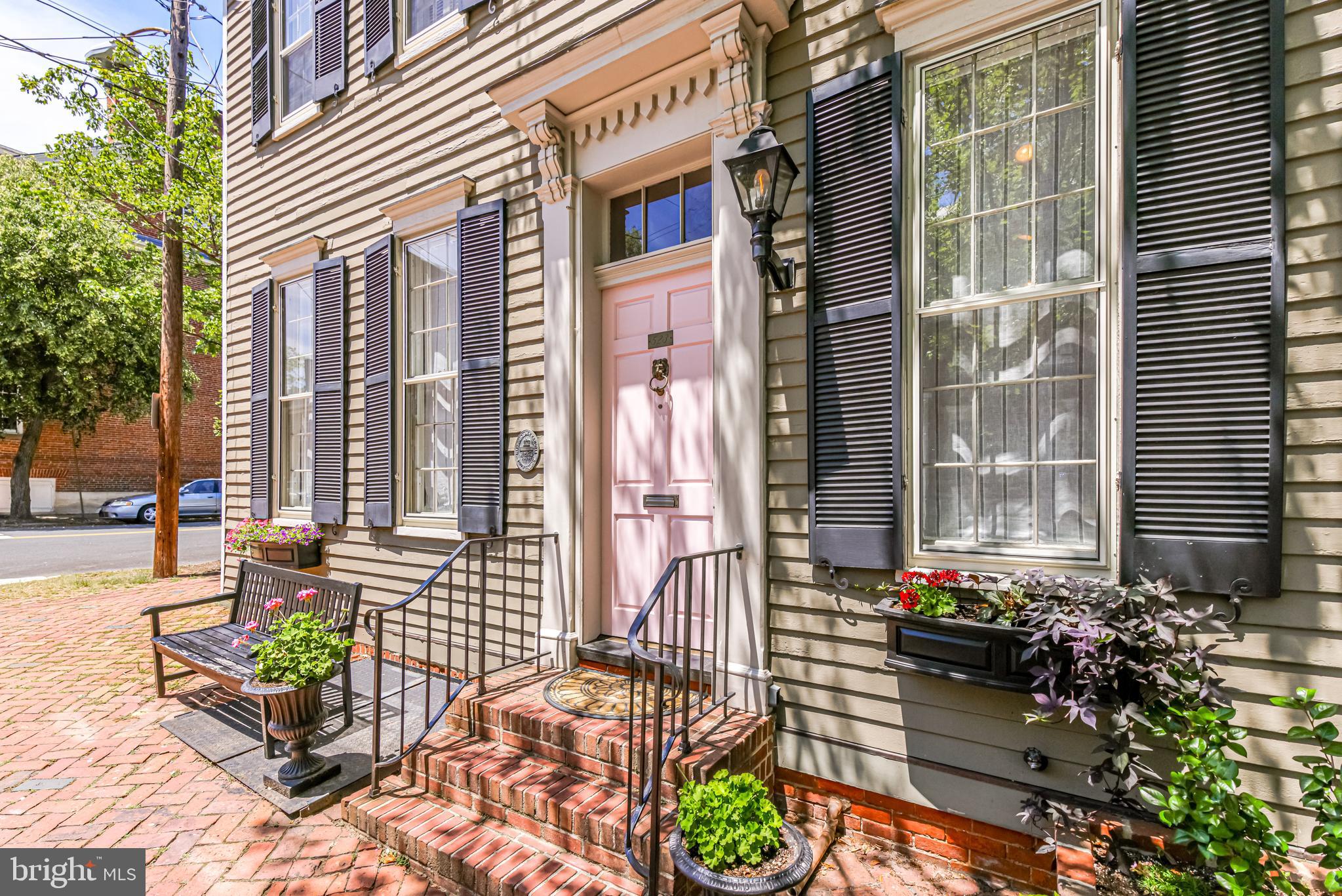 Welcome to Old Town Alexandria’s 523 Duke Street, a truly special home with wide-open spaces flooded by natural sunlight. Originally two historic houses they were splendidly combined many years past making for oversized rooms, a rare find in Old Town.  Beautifully updated, it now offers a unique blend of contemporary and traditional features. 

This spacious corner house is open on three sides, facing southwest, presenting unobstructed sunlight from dawn to dusk. The best of both worlds, a historic Old Town residence with high quality modern upgrades. The gas lighted front entrance foyer welcomes you into 11-foot ceilings with original wide board heart of pine floors. The formal dining room offers elegant seven-foot windows, custom made roman shades and a historically rich exposed brick wall dating back 178 years.  The adjoining living room again illuminates with an abundance of natural lighting throughout the day with its four oversized seven-foot, nine over nine pane windows with custom roman shades. The 11-foot ceilings are complimented by six-inch crown molding, arched entry ways and a custom French gallery art hanging system throughout. A separate den, with French glass doors opening directly to the patio, provides a private more intimate space for television viewing and reading. The newly renovated kitchen with Viking and Sub-Zero appliances are complimented by cream quartzite counter tops, custom cabinets and warmed by original pine flooring and a wood burning, newly relined fireplace. This modern roomy kitchen opens to an flagstone patio surrounded by old brick walls and mature birch tree, offering even more wide-open space for private outdoor entertaining and relaxation. 

Only one flight upstairs provides a large primary suite as well as two additional sizable sunny guest bedrooms with full bath and an abundance of closet space. The primary suite is naturally lighted by four windows on two sides as well as a skylight for moonlit evenings. The separate walk-in closet opens to a newly renovated primary bath with white marble, porcelain floors, standalone tub and a separate walk-in steam shower. Again, naturally lighted by multiple windows and a skylight with an exposed brick wall providing a warm reminder of this house’s history. 

Additional space for work, exercise, dry storage and more is provided by a large cement basement with easy access from the recently installed interior staircase. Insulation from noise and weather have been provided by new storm windows on all 26 windows as well as new insulation throughout the ceiling and crawl space. The house is kept cool by a recently installed HVAC unit and warmed by natural radiated heat. 

Located in the heart of Old Town, this home is truly just steps from it all…easy stroll to the farmers market, afternoon picnic on the Potomac, waterfront dining, art exhibits, a short ferry or easy bike ride into Washington, and so much more.