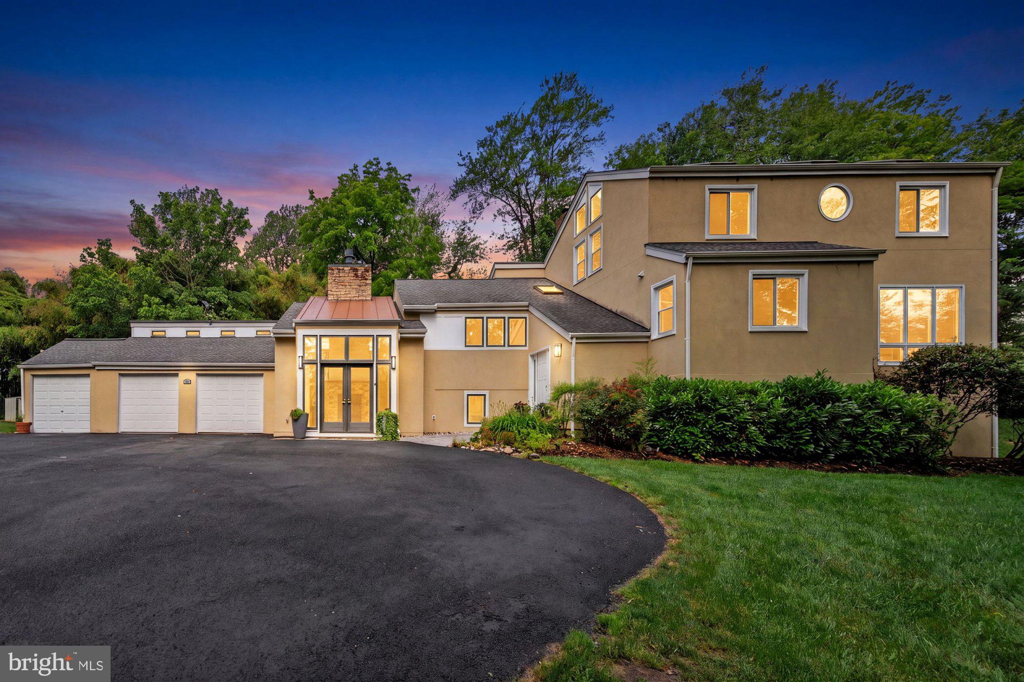Tucked away on a private 1.1-acre lot in McLean, this exceptional home offers 5 bedrooms, 4 full baths, and 4,511 finished square feet surrounded by mature trees and professionally designed landscaping. A welcoming foyer with vaulted ceilings and custom built-in cubbies creates a functional mudroom space and sets the tone for the home's thoughtful design. The main level is ideal for both everyday living and entertaining, featuring vaulted ceilings, a spacious living room with a fireplace, a formal dining room with a fireplace, and a gourmet kitchen with a large center island, granite countertops, abundant prep space, and a breakfast area. The main level also includes two bedrooms and two full baths, including the owner's suite with private deck access, a sitting room, walk-in closet, and a spa-inspired en suite bath with dual vanities, a soaking tub, and a walk-in shower. Upstairs, two generously sized bedrooms with vaulted ceilings and skylights share a full hall bath. The finished lower level expands the living space with a large recreation room featuring a third fireplace, a fifth bedroom, and an additional full bath. Outdoor living is highlighted by a spacious entertaining deck, private owner's suite deck, stone patio, fire pit, hot tub, and a beautifully landscaped Japanese-inspired garden offering exceptional privacy and tranquility. Ideally located just minutes from Tysons Corner, Spring Hill Metro, shopping, dining, parks, and major commuter routes, this home is within the top-rated Langley pyramid.