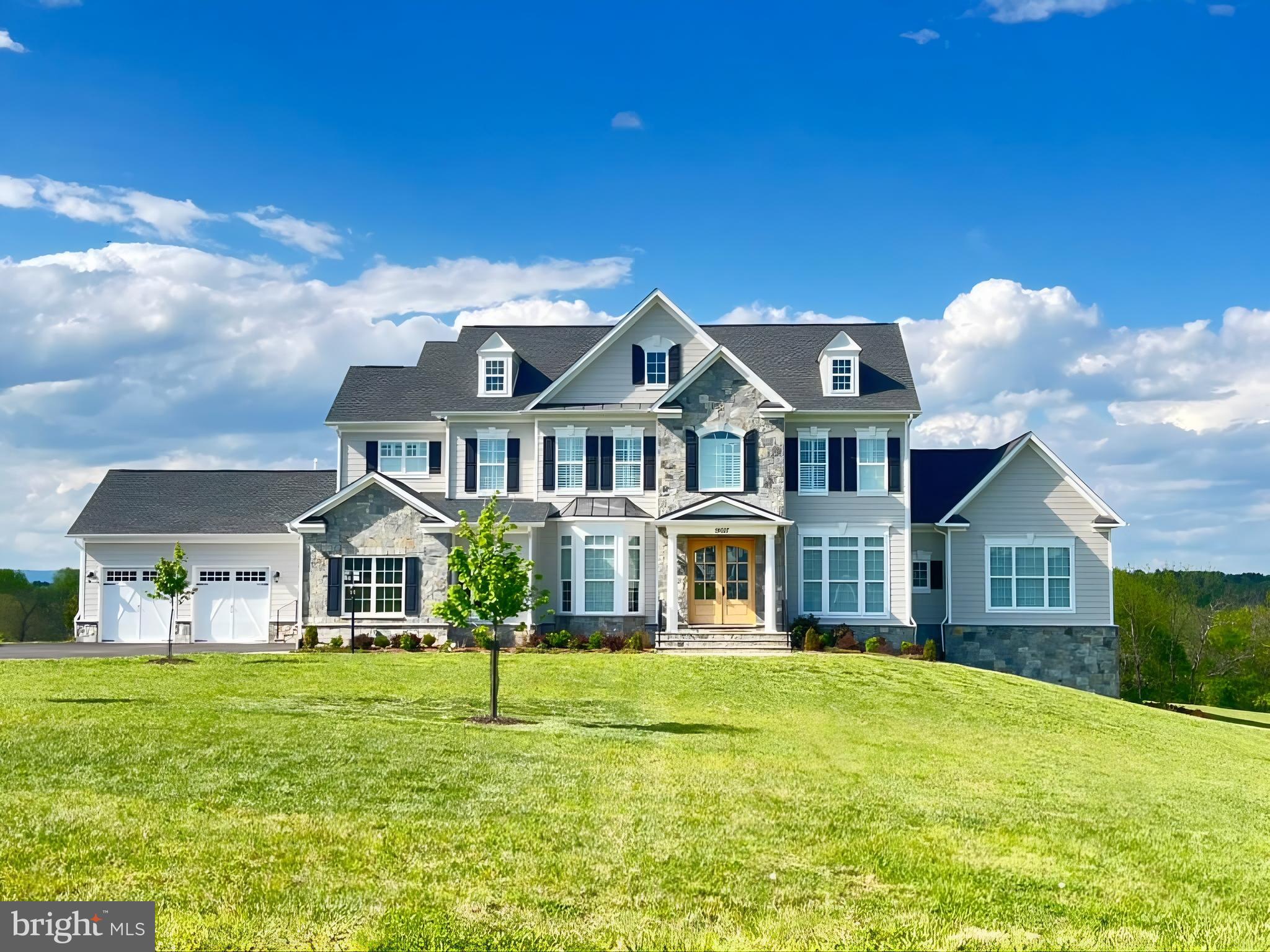 Magnificent six-bedroom estate set on 15 private acres, featuring breathtaking views of the Blue Ridge Mountains and direct frontage along North Fork Goose Creek. Upon entry, you will notice the hand-scraped hickory hardwood floors throughout the main and upper levels of the home. The formal dining room and library are first to greet you. Continuing to the family room, you will notice the abundance of natural light, gas fireplace, coffered ceiling, and access to the composite deck for wildlife viewing and entertainment. The kitchen is a chef's dream with Wolf/Sub-Zero appliances, spacious quartz center island, backsplash, walk-in pantry, under cabinet lighting, gas cooking, InSinkErator, warming drawer, and butler's pantry. The morning room provides plenty of additional space to eat and enjoy views of the property. Just off of the kitchen is access to the mud room and both garages offering parking for four vehicles. The main-level guest suite is a private sanctuary, complete with deck access, a separate sitting area, walk-in closet, and a full bath with tiled shower—perfect for extended guests or multigenerational living. On the opposite wing of the main level, you’ll find a versatile flex room/office, a den or club room, and a powder room—providing flexible spaces to suit today’s lifestyle. Upstairs, you will find four additional bedrooms, each thoughtfully appointed with its own en-suite bath and plantation shutters. The primary suite is a true retreat, featuring stunning views, a ceiling fan, an expansive walk-in closet, and a spa-inspired bathroom. The luxurious bath showcases heated tile floors, dual vanities, a freestanding slipper soaking tub, and an oversized walk-in shower with dual shower heads. The upper level also includes a laundry room with abundant cabinetry and a utility sink for added convenience. All bathrooms throughout the home are enhanced with heated bidet toilets, offering an elevated level of comfort. The fully finished basement is designed with entertaining in mind. The expansive recreation room features a well-appointed kitchenette complete with granite countertops, a dishwasher, and a built-in beverage refrigerator. From here, enjoy direct access to the media room, where all theater equipment and seating convey with the home. Ideal for guests or extended stays, the lower level also includes a sixth bedroom and a full bathroom. Additional highlights include ample storage space, dedicated hobby areas, a private workout room, and convenient access to the rear yard. A Generac 24kW generator also conveys, providing added peace of mind. This exceptional property offers a rare opportunity to enjoy panoramic views and water frontage just minutes from town—truly a remarkable place to call home.