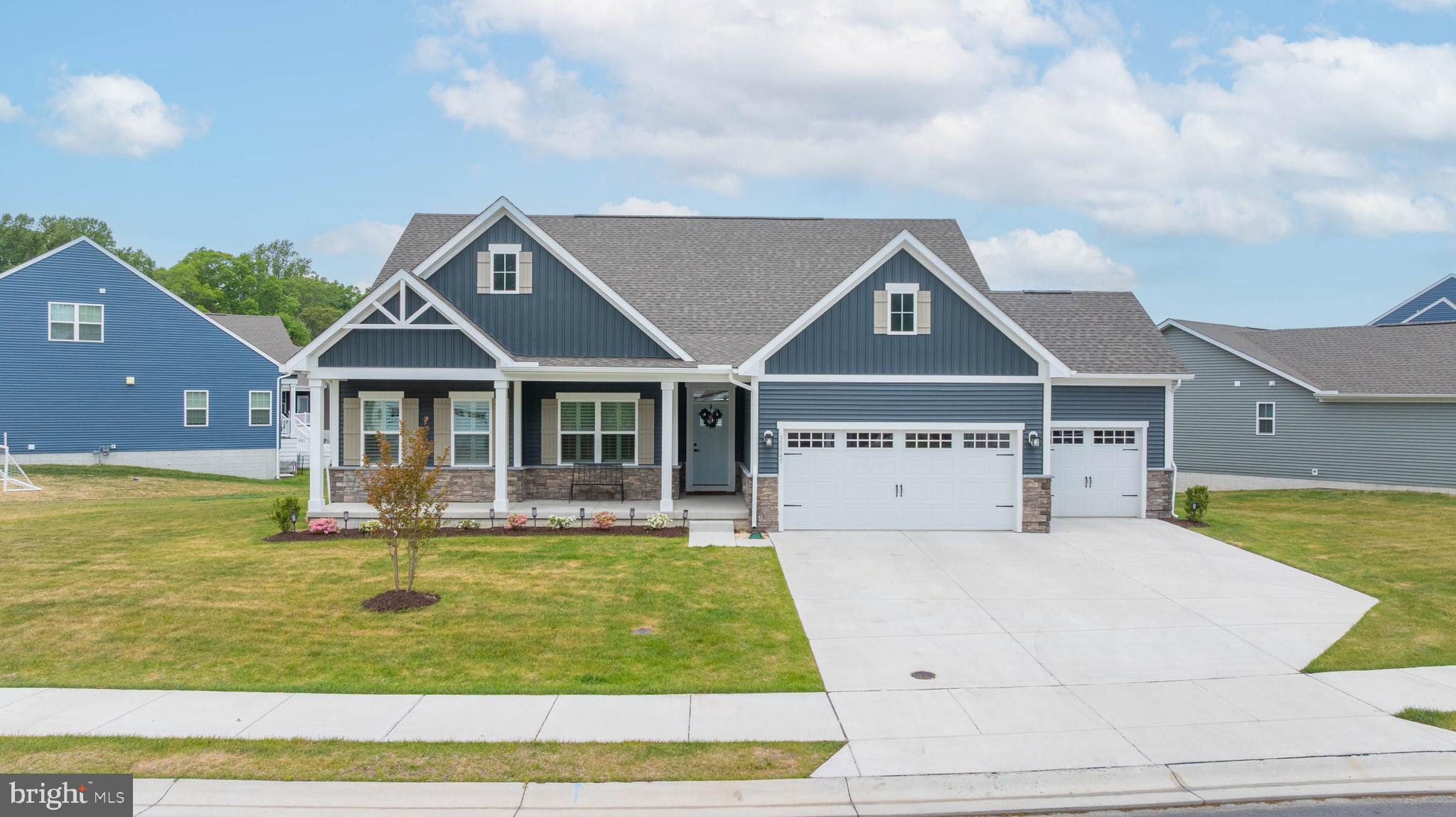 Welcome to this stunning newly built coastal Ranch/Rambler-style home in the sought-after Compass Point community of Lewes. Built in 2025, this beautifully designed residence offers 5 spacious bedrooms and 4 full bathrooms, featuring thoughtfully curated, upgraded finishes throughout.

The open-concept layout blends modern elegance with everyday comfort, complemented by a mix of luxury vinyl plank and carpet flooring. Interior highlights include nickel finishes and quartz countertops throughout the bathrooms to match the kitchen, along with additional exterior outlets for enhanced roofline lighting. All systems in the home are brand new, providing peace of mind and efficiency for years to come.

The primary suite features a tray ceiling with recessed lighting and a ceiling fan, creating a bright and inviting retreat. The space also offers a dedicated sitting area and a well-appointed en-suite bathroom featuring a glass-enclosed walk-in shower, soaking tub, and tile surround, along with abundant natural light for a spa-like feel.

The fully finished basement adds exceptional living and entertaining space, while the garage—complete with an EV charger—offers both convenience and functionality. With a total of 3 garage/carport spaces and 2 additional driveway spaces, there is ample room for parking.

Situated on a beautifully landscaped lot that backs to a dry pond, the property offers a serene and private outdoor setting.

Ideally located just minutes from downtown Lewes and nearby Rehoboth Beach, residents enjoy easy access to miles of pristine coastline, boating, award-winning dining, entertainment, and premier outlet shopping.