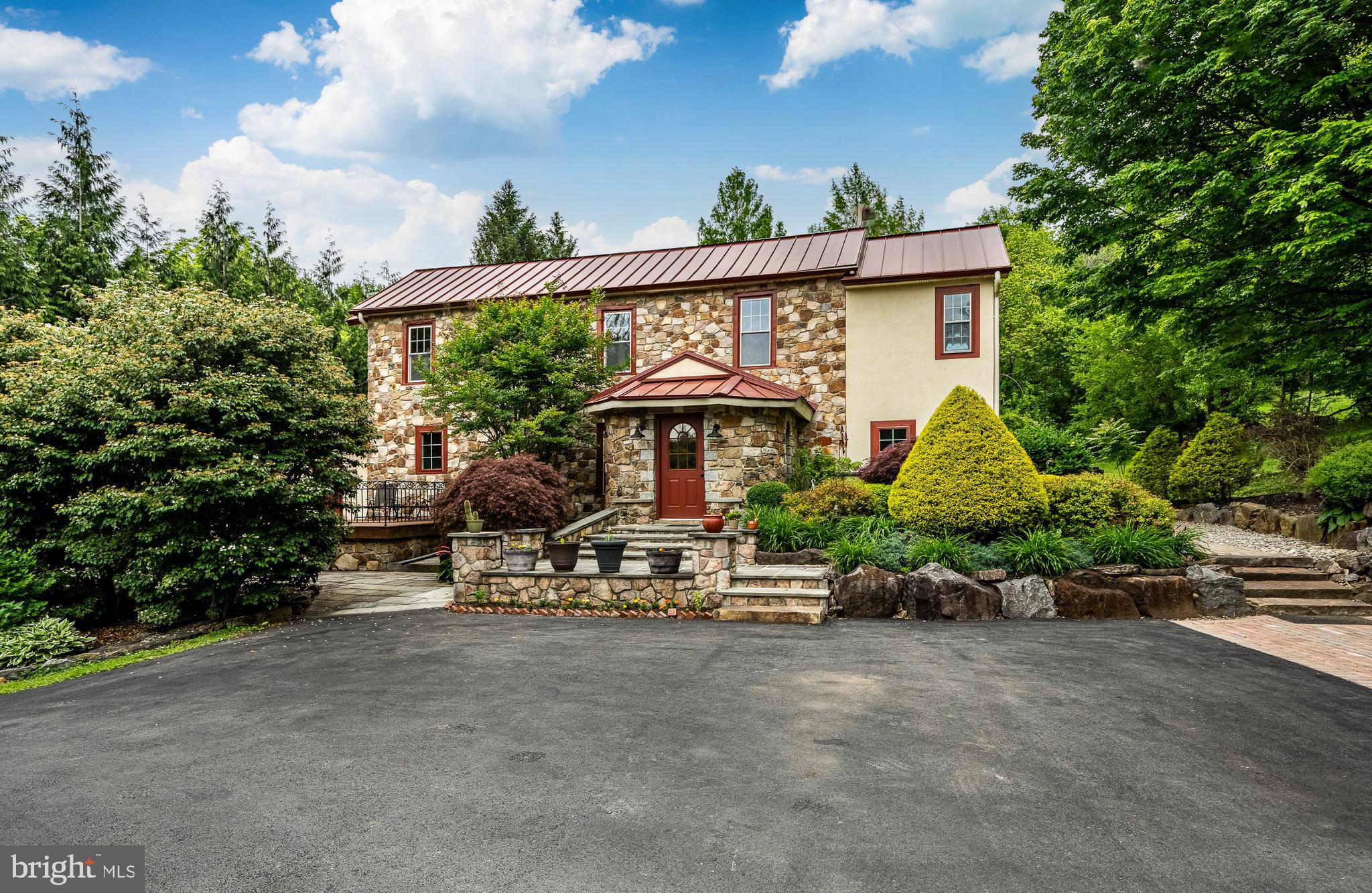 This is a fabulous c.1886 house where the creative owner changed and altered spaces to create the unique home you see today! This is not your average cookie-cutter house plus the property offers three additional finished spaces! One finished space is above the garage, and two are in the Barn. The extent of the home’s creative character is immediately felt with your first step into the Foyer. The room’s vaulted ceiling is sheathed in reclaimed natural mahogany and the oval shaped room features arched windows and a slate floor with beveled edges. Stone replaces a traditional chair rail and a stone arched doorway welcomes you into the adjoining Great Room and Kitchen. Here, the floors draw your attention as they are perfectly crafted with a rich combination of ash, maple, walnut and mahogany wood. The vaulted ceiling in the Great Room is beautifully sheathed in reclaimed mahogany and the light from three skylights brightens the room. The east end of the Great Room features an incredible dry laid stacked stone wall with an arched window at its center. All of the handsome Kitchen cabinets where made on site and the center island’s countertop is made from a slab of black walnut with a live edge. The kitchen counters are beautiful Italian soapstone. Thanks to several interconnecting rooms, this home is perfect for someone who loves to entertain as there is plenty of space and a wonderful flow. The Dining Room features exquisite mahogany dental crown molding and special woodworking around all of the doors. The next room is the Den which houses the staircase and a cozy gas fireplace. Finishing the main level is the Bar Room which features a wall of custom cabinets surrounding a bar with a wine cooler below. This dramatic space also features four arched windows set in a stone wall. The Powder Room is located here. A door leads to a large mahogany deck with a hot tub - a wonderful location for intimate dinner parties. Upstairs is a wonderful Primary Suite with a fabulous bathroom and walk-in closet. On this level are two additional bedrooms and an updated Hall Bathroom. The upper level hall is also home to the Washer and Dryer. For the chef in the house, there is a wonderful stone and brick pizza oven off the back terrace! Adjacent to the home is a Three Car Garage. One Garage bay has been converted into a home Gym which allows you to workout daily in your own personal gym/yoga room. Over the three car Garage is a spacious finished space with a great room, additional room, and full bathroom. In what was once the Barn, then the workshop for Brandywine Cabinetry, you will now find two finished spaces. There are two lovely ponds on the property, one of which is stocked with bass and coy while the other has a soothing waterfall. For the young at heart, there is a great tree house. This fine property is truly the work of a creative master craftsman and represents the highest quality workmanship. Additionally, a buyer will enjoy views of the nearby Brandywine Creek. A new owner will also be proud of the fact that parts of the property were featured in a Wyeth painting. All of the home’s mechanical systems have been thoroughly updated with high-end equipment. Located in the highly sought after Unionville-Chadds Ford School District, this wonderful property also enjoys very low taxes!
