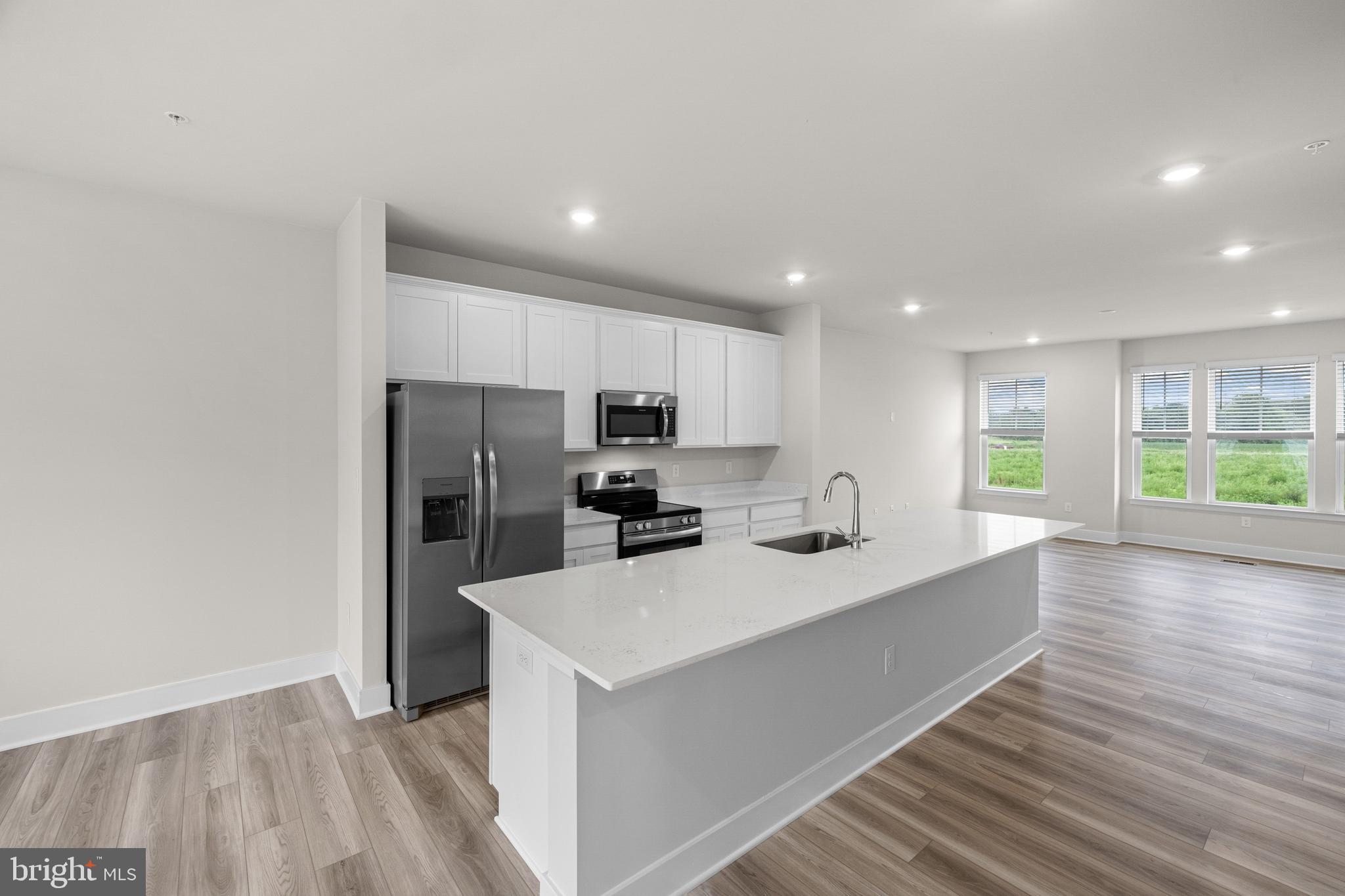 Backing to open space for added privacy, this beautiful new construction townhome offers the perfect blend of comfort, style, and convenience. Residents enjoy exceptional community amenities, including a clubhouse, resort-style swimming pool, fitness center, walking and biking trails, playground/tot lot, pickleball and multi-sport courts, dog park, and a scenic lake woven throughout the neighborhood. Ideally located near Easton, waterfront destinations, shopping, dining, and major commuter routes.

This luxury three-story townhome at Lakeside at Trappe features a 2-car garage, 3 bedrooms, 2 full baths, and 1 half bath, along with versatile recreation spaces perfect for entertaining, working from home, or relaxing with family. The gourmet kitchen is highlighted by a spacious quartz center island, walk-in pantry, stainless steel appliances, and luxury vinyl plank flooring throughout the main living areas. The spacious owner’s suite offers a large walk-in closet and private bath. Additional features include ceiling fan prewiring in the bedrooms and main living areas, plus smart home technology with a Ring video doorbell and smart front door lock.
