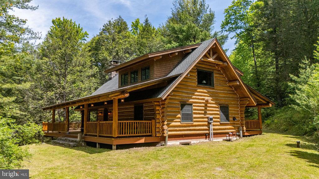 Escape to your own private Northern Pennsylvania retreat with this custom-built Montana log home offering 395 secluded acres in Tioga County. With 4-5 bedrooms and 3 full baths, the home features a stunning Rumford fireplace handcrafted from granite fieldstone, soaring ceilings, an open-concept layout, loft, and finished lower level with family room, bar area, full bath, and guest bedroom. Enjoy expansive covered porches and a large deck overlooking the surrounding countryside. The property includes 108 acres of mostly open land with a livestock barn and approximately 100 tillable acres along the river, offering ample agricultural potential, plus 287 acres of predominantly wooded northern hardwood forest. Mature red and white oaks provide exceptional wildlife habitat and income potential, with timber untouched since 1993. The property borders land intensively managed for deer and turkeys by a nationally acclaimed deer biologist and routinely featured on television and online hunting shows, creating exceptional opportunities for hunters and wildlife enthusiasts. Located near the end of a dead-end road, a nearly 1-mile-long driveway provides extreme privacy. Ideal for hiking, trail riding, hunting, recreation, farming, or year-round living, this exceptional property offers seclusion with modern amenities nearby and is a short drive to Corning, NY and the Wellsboro Grand Canyon. OGM's negotiable and receiving substantial yearly lease payments. Property includes customized wildlife management plan.