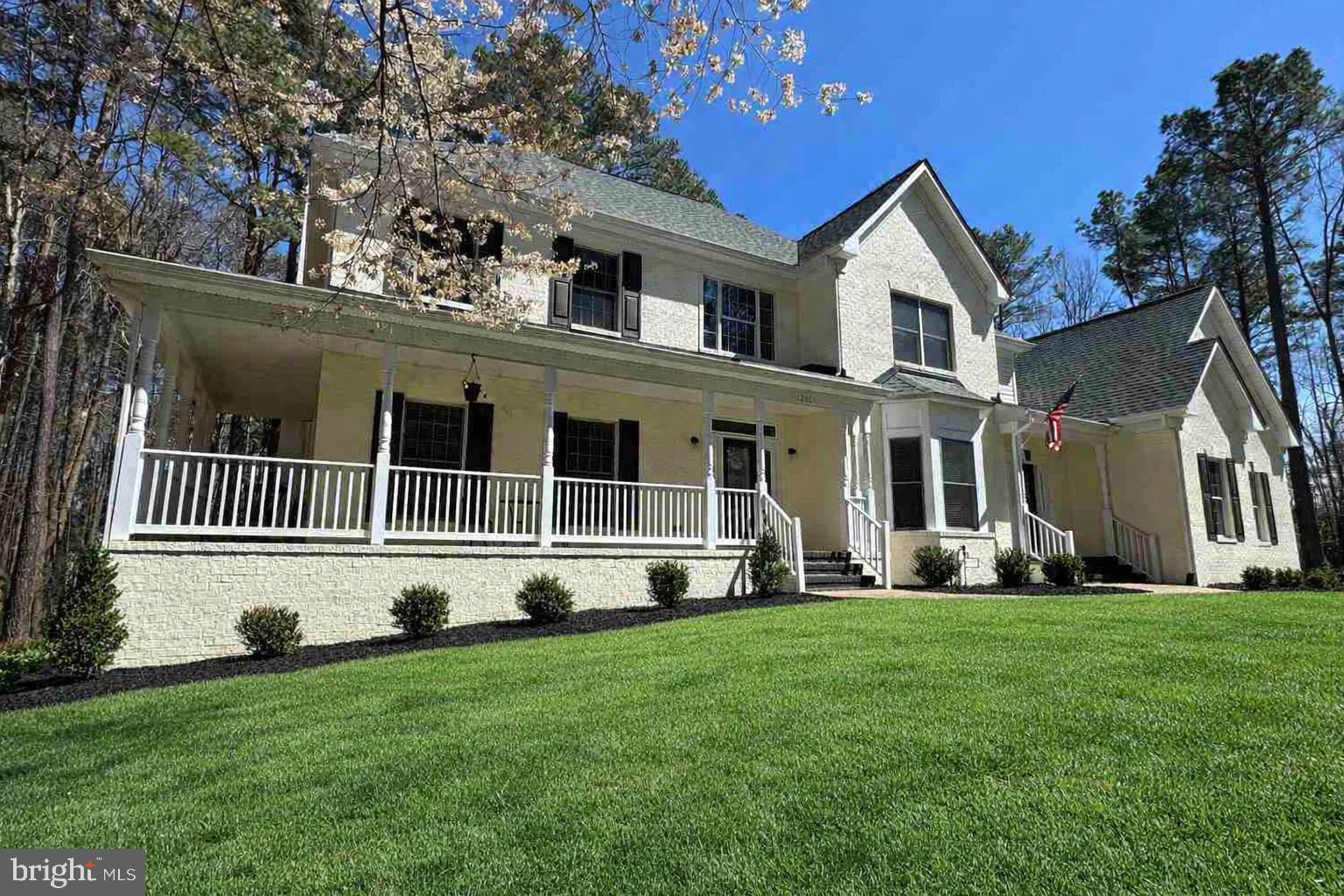 INCREDIBLE VALUE!!!
WELCOM HOME to your spectacular custom brick French Manor Farmhouse style home situated on approximately 4.5 wooded acres in the highly desirable Honor Bridge Farm Estates section of the prestigious 2,350-acre Fawn Lake Community featuring a 288-acre lake with over 7 miles of shoreline and a deep water marina, wildlife sanctuary, fitness center, an Olympic-sized swimming pool overlooking the beautiful lake, walking trails, and an Arnold Palmer designed golf course with a private country club, golf pro shop, and driving range. The Fawn Lake community has many groups, clubs, and leagues for any type of enthusiast. Enjoy a casual meal with family and friends at the Lakeside Grille or an upscaled dinner at the Harbor Club.

Are you looking for ultimate privacy in an amenity-packed gated golf and lake community? Well look no further than this beautiful dream home under a canopy of trees with an extended driveway. Adorned by newly installed river stone hardscape complete with new landscape lighting all around. The driveway is flanked by brand new stone walls with new lighting, and all road facing stone fence pillars have new stone as well. The main and upper levels have oak hardwood flooring throughout. The entire interior and exterior were painted in 2022-2023.

A grand two story Foyer is flanked by a gracious Formal Dining Room and a Private Lounge with two sets of French Doors. The spacious Family Room with floor to ceiling windows and propane fireplace opens to the Gourmet Kitchen featuring granite counters, stainless steel appliances, and a marble tile backsplash. A Main floor Bedroom with large closet (currently used as an office) and adjoining Full Bath, plus a quaint side porch entrance leading to a Mud Room, complete the main level.

The grand oak staircase and additional back staircase lead to the upstairs with an incredible Owners Suite with large double walk-in closets and a fabulous newly remodeled luxury Spa Bath featuring a large jetted tub, heated tile floors, glass and tile shower, dual vanities, and heated towel rack. A spacious Bedroom with adjoining Full Bath and large walk-in closet, two additional Bedrooms with large walk-in closets share a Full Bath with dual vanities. An enormous Bonus 5th Bedroom offers unlimited living options. A spacious Laundry Room with ample cabinetry complete the upper level.

Designed for entertaining, the bright and open walk-out lower level features large windows and French Doors offers plenty of natural light. A huge Recreation /Family Room with a Full Custom Wet Bar /Kitchenette, Game Room, large Bedroom with shared Full Bath, and plenty of unfinished space for storage!

Immersed in privacy, the backyard features a large deck that blends seamlessly with the lush lawn watered by a 12-zone irrigation system and gorgeous landscape design, creating an ideal environment for outdoor dining, resting, relaxing, and entertaining.  Includes a whole house Generac generator. This home truly provides the perfect harmony of tranquil indoor and outdoor living. Complete with a large 4-Car Garage, Charge Point+ Tesla EV charger, and extended parking lot driveway! New Roof in 2022! 

The beautiful gated Fawn Lake Community offers amazing amenities such as a boating recreational lake, beach, golf course, tennis courts, soccer & ball fields, dog park, volley ball courts, walking trails, Club House, marina, fitness center, restaurants, Country Club, playgrounds & so much more! Located on the countryside near protected park lands and only a few miles to the farm market, wineries & award wining breweries!