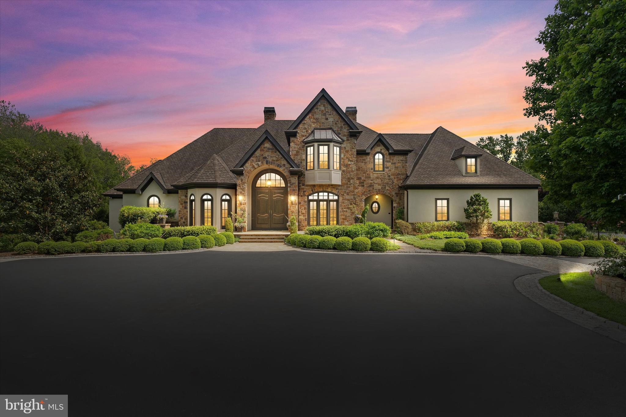 Step into timeless elegance. This extraordinary custom-built estate by Dewson Construction exemplifies superior craftsmanship, luxury, and thoughtful design. Perfectly nestled on a beautifully landscaped almost 3 acre setting in one of Greenville’s most coveted locations, this home offers meticulously designed living spaces, blending classic architectural details with modern comforts.

From the moment you walk inside, you’re welcomed by a stunning oversized front door, arched openings, exquisite millwork, and rich hardwood floors laid in a herringbone pattern. The main level is an entertainer’s dream, offering a seamless, open-concept layout that still manages to feel warm and inviting. The kitchen, breakfast area and great room are bathed in natural light, with expansive walls of windows showcasing scenic views of the private grounds. A large balcony and spacious screened-in porch flank the breakfast area. Custom built-ins, finishes and cabinetry, and cozy fireplaces enhance the home's inviting atmosphere.

The main floor features a luxurious primary suite with a spa-like bath, an oversized custom walk-in closet, and tranquil sitting area create the perfect retreat. A private study, formal dining room that opens to a wet bar and butler’s pantry, two powder rooms, a second entrance into a customized mud room with a 3 stop elevator complete the main floor.

Upstairs, four spacious bedrooms offer walk-in custom closets and private baths. One of them could serve as a second primary suite if needed. A versatile landing area is ideal for a second office, reading nook, or homework station.

The walk-out lower level offers a full suite of lifestyle amenities, including a media room, daylight family room with fireplace leading to a patio, billiards area with a full wet bar, exercise room, and a full bath with 2 showers, perfect for poolside convenience or post-workout refresh and another powder room. French doors lead to the lush backyard, where the views stretch out over manicured lawns and garden spaces.

Every detail is curated for luxury: from the high-end finishes and lighting throughout, to the oversized windows and high ceilings that enhance the open, airy layout and speak to timeless quality.

Outdoor amenities rival those of a private resort: travertine hardscaping, a heated in-ground saltwater pool, outdoor kitchen, firepit area, and expansive mature landscaping and panoramic views.

Additional highlights include an elevator, a laundry room on each floor, geothermal HVAC, a whole-house generator, a 3-car garage with California Closet systems, and generous storage space throughout. The home is wired for smart technology, surround sound, and high-speed internet, offering seamless modern functionality. Every detail reflects the renowned quality of Dewson Construction.

Just minutes from Greenville’s finest dining, shopping, and cultural attractions, this is a rare opportunity to own one of the area’s finest estates.