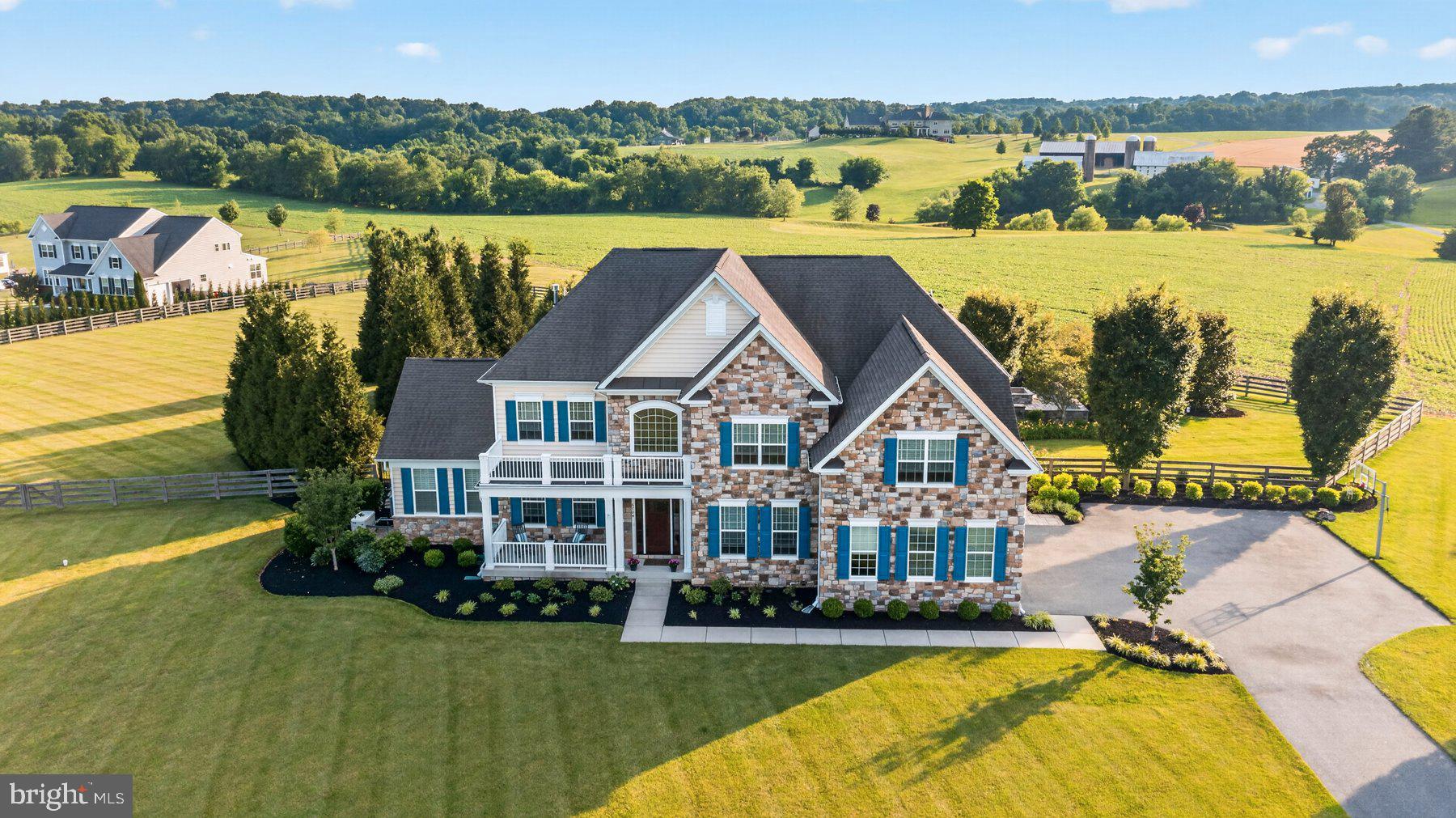 Coming soon-Only a select few get to  call this prestigious community home. One of 24 total homesites situated in southern Carroll, Century school school district, nearby Piney run park, downtown Sykesville “Best little town winner”. This is a First time offering in Chimney Rock. 
Dwell amidst commanding vistas, on 2-1/2 acres backing to hundreds of acres of farmland and gently rolling hillsides. Exquisitely positioned for captivating sunsets in a warm weather Paradise. Bespoke outdoor living at its finest. An ideal place to gather and enjoy the company of friends and family year-round . Luxuriate poolside with a cool beverage at the outdoor living area, relax on the covered porch complete with dual propane heaters,  & built-in television to enjoy the game. BBQ chefs will delight in the  outdoor kitchen with built-in grill. Be soothed by the cascading water in the heated, inground pool or enjoy cool evenings by the built in fire pit. 
A welcoming front porch invites you through the custom mission style entry. Inside you will find a gracefully appointed home with 9 foot ceilings on the main level and a grand two-story entry and more than 7900 ft.² of finished living space on Three levels. The main level offers dual stairs to the second level, a formal dining room with double crown, moldings and chair, rail and an adjoining butlers  pantry with wine fridge. The gourmet kitchen offers induction cooking, double ovens, and a huge island open to the morning room and family room with  fireplace. A well appointed office overlooks the rear yard. A sunlit conservatory rounds out the first floor. The upper level offers a primary bedroom suite boasts a commanding view of the rear yard, an adjacent sitting room, dual walk-in closets with built-ins, a spa like,  tiled primary bath with an oversized shower, and dual shower heads. Bedroom level laundry room. Jack and Jill bedroom suites, and an additional bedroom with adjoining sitting area/bonus room. The lower level offers a built-in bar, full bath, exercise room/possible sixth bedroom/in law, suite, as well as a fully appointed home theater with built-in seating, projection and surround sound, and an additional rec room with walk out stairs to the rear yard.