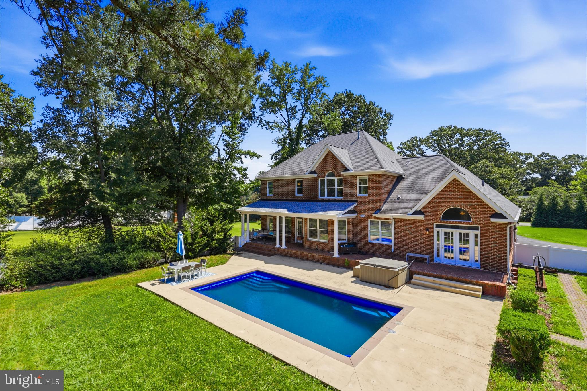 FRESHLY PAINTED AND UPDATED! Unbelievable location - 20 Minutes or less to anything and everything in the metro DMV

This stunning brick home in Alexandria offers space, privacy, and a backyard that truly feels like a retreat.

A welcoming front porch introduces the home, leading into a grand two-story foyer and beautifully designed living and dining spaces. A dual-sided fireplace connects the formal living room and family room, creating a warm and inviting atmosphere for both everyday living and entertaining.

The heart of the home is the open-concept kitchen, featuring a large island, granite countertops, stainless steel appliances, double wall oven, walk-in pantry, and a sunny breakfast area overlooking the backyard.

Step outside to a private outdoor oasis: an in-ground heated pool, hot tub, covered porch, and expansive fenced yard—perfect for relaxing or entertaining.

The main-level primary suite features cathedral ceilings, French doors opening to the patio, and a spa-like bath with double vanity, soaking tub, glass shower, and a custom walk-in closet.

Upstairs, you’ll find five spacious bedrooms, many with walk-in closets and cathedral ceilings, including two with en-suite baths, plus an additional hall bath.

The fully finished lower level is designed for entertaining, complete with a bar area, recreation space, gym, media area, and full bath.

Filled with natural light, high ceilings, hardwood floors, and custom details throughout, this home offers the perfect blend of comfort, space, and lifestyle.