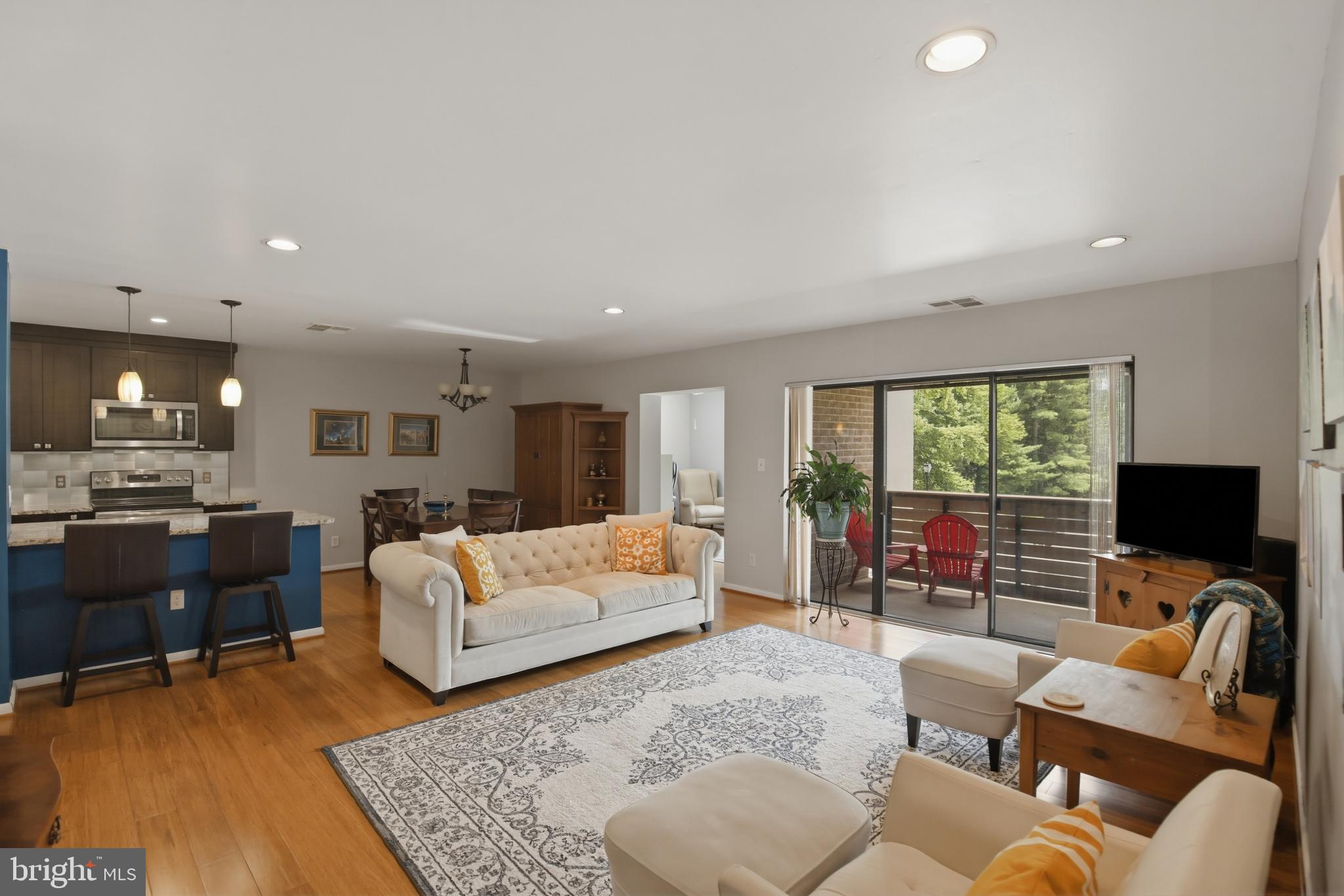 Rarely available, move-in ready 2BR 2BA condo in sought-after Annen Woods! This renovated unit is the largest in the building and offers maximum privacy & quiet located at the end of the hallway. In addition to 2 bedrooms, bonus den offers even more living space! Sunlit den with ceiling fan provides a unique flex space for office, library/reading nook, or hobby area. Newly remodeled gourmet kitchen opened up for a spacious, expanded look & feel open to the dining & living rooms. A unique layout in the community! Renovation included granite countertops & natural wood cabinets. Oversized breakfast bar / island provides lots of prep space & comfortable seating area. Stainless steel appliances including built-in microwave & dishwasher. Pantry provides that all-important, convenient extra storage. Kitchen additionally modernized with tile floors & backsplash. Adjacent dining room offers plenty of space for table & furniture. Huge living room with a ton of natural light. New, beautiful bamboo wood floors and elegant recessed lighting throughout the unit. Large, private balcony perfect for relaxing while reading a book or sipping a cup of coffee. Big primary suite features generously-sized walk-in closet, ceiling fan, expansive light-filled windows, and spacious fully renovated ensuite bathoom with walk-in shower, new tile work & vanity. Large second bedroom with abundant closet space & ceiling fan. Bright hall bathroom with full bathtub, lots of vanity space & cabinet storage, oversized mirrors, tile floor. Roomy utility room has plenty of space for all your storage needs. No worries with the new (2024) HVAC, hot water heater, and washer & dryer! Annen Woods is a secure gated community, beautifully landscaped with excellent maintenance and first-rate management. Enjoy the generous amenities - relax at the in-ground pool, have friends over at the clubhouse, get some exercise on the tennis courts, or just walk around the peaceful tree-lined grounds. The condo building features hard-to-find elevator access and a unique, serene lobby solarium bringing nature inside. Location is best of both worlds. While this quiet, hidden gem, gated community is tucked away among the trees; the surrounding area is the center of Pikesville with all of its conveniences - grocery, shopping, dining, major routes - just a quick drive away. Don't miss out on this unique opportunity to live in the popular Annen Woods community!