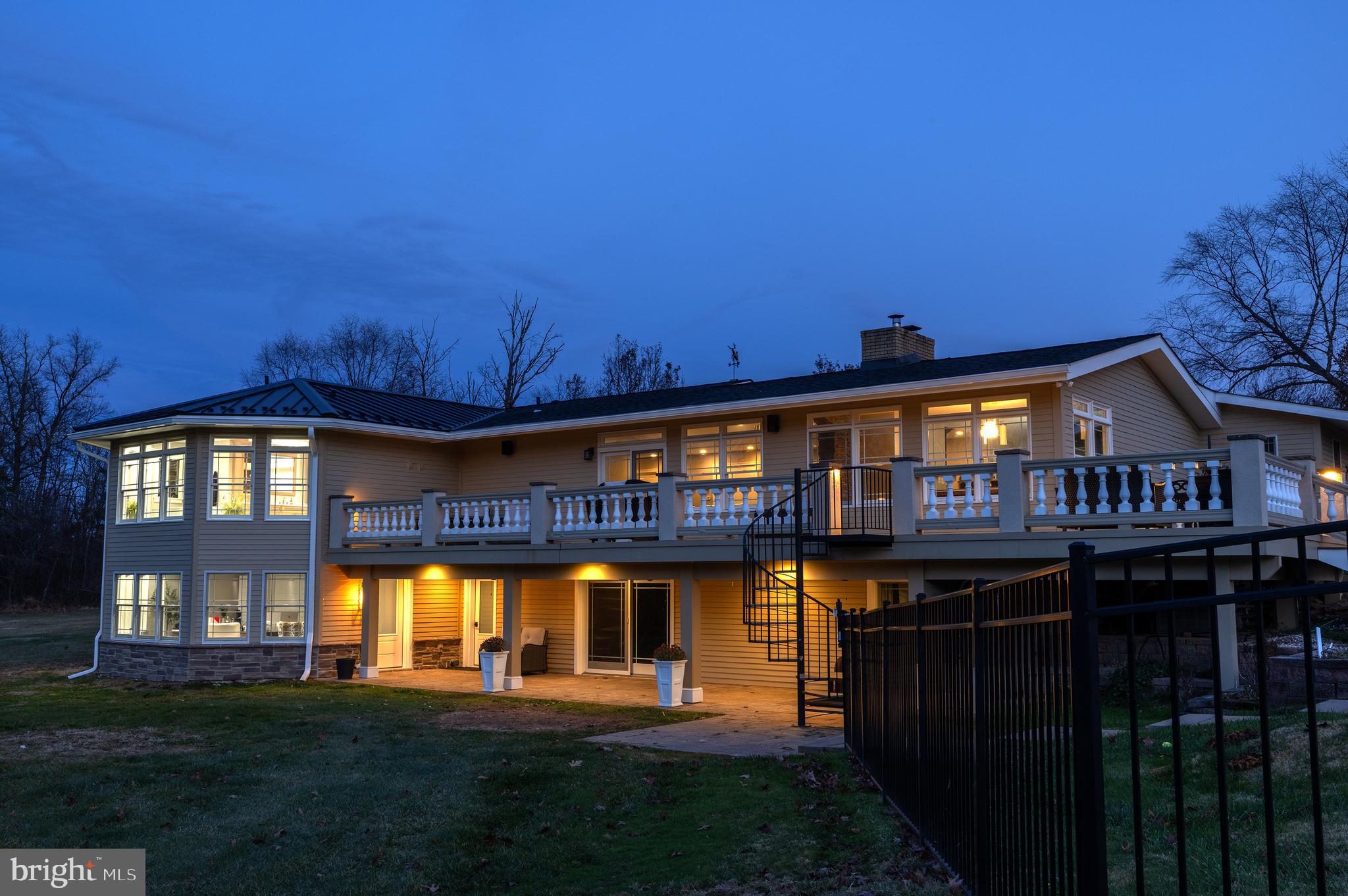 Sprawling 10+ acres compound offers everything you could possibly want in a fully updated and modern Central Bucks East SD home, just minutes from historic Doylestown Borough, New Hope, and the quaint, historic villages of greater Bucks County.  The wide open main level features high ceilings, panoramic views of the back field and forests, and flows out to a wrap around deck which descends to the swimming pool.  The fully updated and equipped chef’s kitchen includes stately stonework, a 6 burner + grill Viking built in range with double oven, all stainless steel appliances, built-in microwave in the island, Sub Zero fridge, large pantry, a breakfast bar and open plan eat-in dining room.  The main-level primary bedroom has been expanded with a brand new impeccable bathroom addition, complete with double custom vanities, a large freestanding luxury tub, and huge walk-in shower.  Double oversized walk-in closets, vaulted ceiling, and convenient hallway laundry make the main level living very convenient.  Two additional bedrooms on the main level and a hallway full bath, and guest powder room round out the first floor.  The finished lower level is at-grade and features a bright brand new office with wet bar, a large family room with fireplace, two additional bedrooms, a large exercise/bonus room and full bath.  Almost entirely finished, the lower level opens out to a huge covered patio almost the same size as the deck above, and an unfinished room could be on opportunity for a second full bath or powder room.  Outside, down the second driveway and next to the pond, you will find a tremendous outbuilding: the 60’ x 80’ garage.  Three roll up doors (two 14’ and one 12’), a clear span inside, with a 16' clearance to the finished ceiling, heated and cooled and conventionally framed and insulated, it can serve a wide variety of hobbies or collections from cars, RV, carpentry/contracting, horses, etc!  Walk or ride the grounds of the property and enjoy a partially wooded retreat with a creek running through and soak in a pastoral country setting that’s easily commutable to the greater Delaware Valley area.
