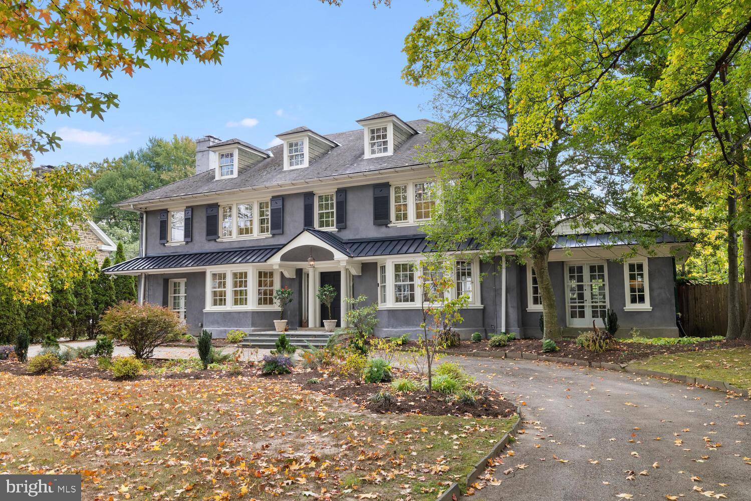 Simply fabulous center-hall sited in the charming West Mt Airy neighborhood of Philadelphia.  This exquisite residence, built circa1920, seamlessly blends timeless elegance with modern luxury. The stucco over stone exterior exudes a classic charm, while the meticulously maintained interior invites you to experience a lifestyle of comfort and sophistication. Step inside to discover a spacious layout adorned with rich hardwood and ceramic tile flooring.  The living room which is to the right of the foyer, runs from the front to the back of the house, with a large bay window at the front and a bank of windows at the back.  There are plenty of places to share meals, in the large formal dining room, the casual "breakfast room, or at the large kitchen island. Light streams in from the Palladian window on the landing as you stand in the spacious foyer. The heart of the home is the gourmet kitchen, featuring upgraded countertops, a large island, and high-end appliances, including a built-in range, self-cleaning oven, and a refrigerator with an icemaker. The breakfast room  is perfect for casual dining, while the formal dining room sets the stage for elegant gatherings. With six generously sized bedrooms, including a main suite with sitting room and luxurious en-suite bathroom, this home offers ample space for relaxation and privacy.  The living spaces are enhanced by thoughtful details such as recessed lighting, built-ins, and a cozy wood-burning fireplace, perfect for creating a warm ambiance on chilly evenings.  An additional stairway leads to a partially finished basement, offering endless possibilities , whether as a recreation room, home office, or home gym.   There is a beautiful  full bath in the basement for convenience.  Outside, the property boasts extensive hardscaping, providing a beautiful backdrop for outdoor entertaining or quiet reflection. The well-maintained grounds include an outbuilding and a play area, ideal for enjoying the outdoors.  In the mild weather, the expansive pergola is hang out central. Ample driveway parking ensures convenience for you and your guests. This home is not just a residence; it's a lifestyle. Enjoy the tranquility of suburban living while being just moments away from local amenities, parks, scenic walking paths of the Wissahickon Valley, and all the culture of Philadelphia.  With its blend of classic architecture and modern comforts, this property is a true sanctuary, ready to welcome you home. Experience the perfect balance of luxury and warmth in this exceptional residence.