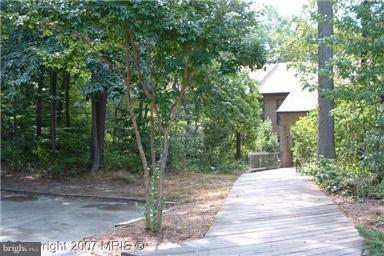 Mid-level condo facing woods. No stairs, just walk right to your front door. Great location, close to shopping, dining, Pax River, schools and more. Unit # is 1043