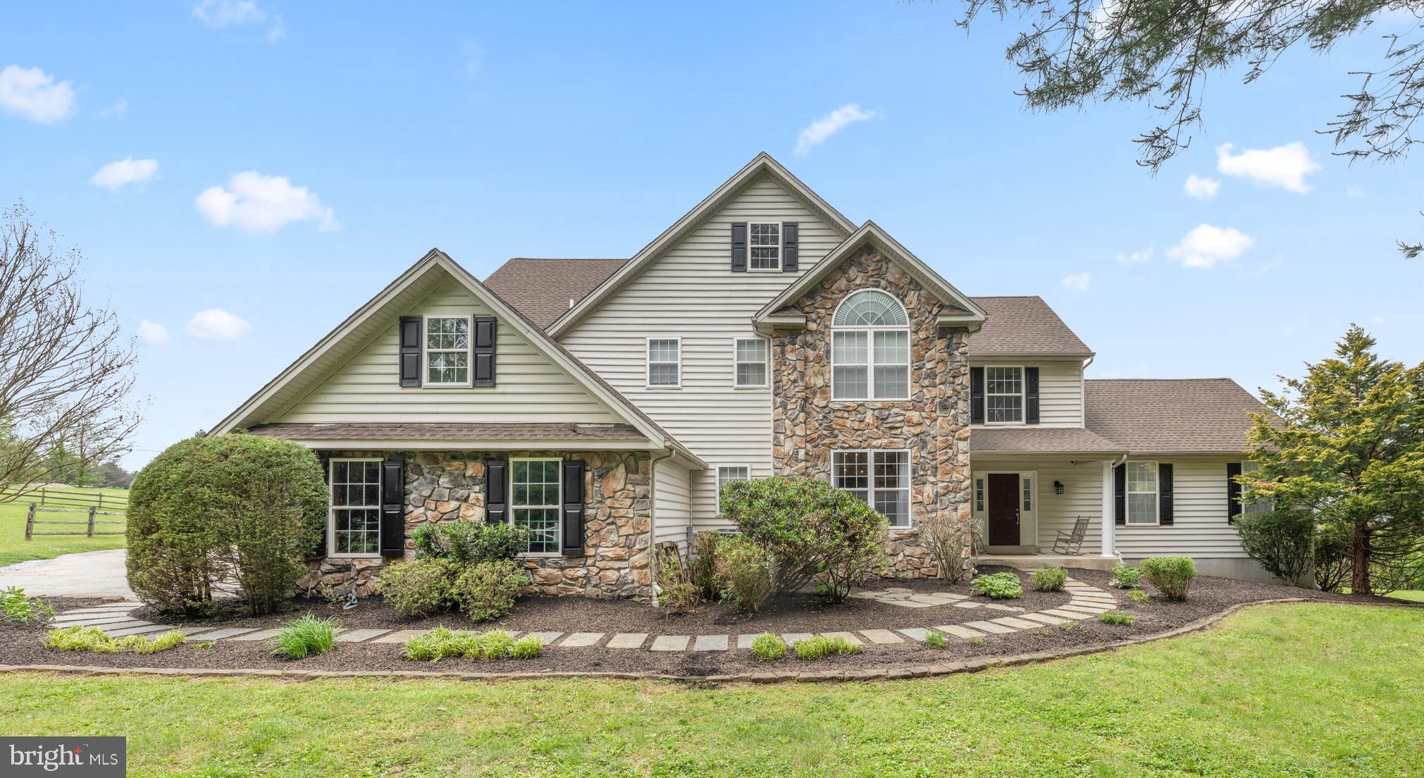OPEN HOUSE SUNDAY 7/12, 2-4PM. Looking for a home in a private setting, yet close to downtown West Chester? This bucolic property is perched on a gentle berm and offers a rare blend of refined country living in a quiet location within the award-winning Unionville-Chadds Ford School District — just three miles from the vibrant shops, restaurants, and charm of downtown West Chester. A picturesque cherry tree-lined drive winds through the property, revealing an impressive 5,600+ square foot residence privately sited on 4 scenic acres with sweeping Chester County vistas. Thoughtfully designed so the rear of the home captures the breathtaking landscape, the setting is both peaceful and inspiring. Sitting around the fire pit and watching the sunset is stunning!  Inside, the home offers an ideal balance of style and comfort with five bedrooms, four full baths, and one half bath across expansive living spaces. A dramatic two-story foyer with a sweeping turned staircase introduces the home’s elegant interiors. The sunlit living room features soaring windows and a gas fireplace, while the spacious kitchen opens seamlessly to the family room (currently used as the dining room) and rear deck, creating an effortless flow for everyday living and entertaining. The formal dining, a private office with french glass doors, a mudroom and an attached 3 car garage complete the main level. Upstairs, the luxurious primary suite is a true retreat, offering dual walk-in closets, a sitting room, and a beautifully renovated spa-inspired bath with a frameless glass shower and soaking tub. The additional bedrooms are generously-sized and each feature walk-in closets and access to full baths. The fully finished walk-out lower level adds remarkable flexibility with two additional bedrooms, a shared bath, recreation spaces, a gym and abundant storage. Meticulously maintained, the home has seen numerous significant improvements including a newer roof, HVAC system, a new well pump and a GENERATOR. Equestrians will appreciate the ability to ride directly from the property without the need to trailer. The property is beautifully arranged with three separate fully fenced pastures, two paddocks, a three-stall shed row barn with electric, and an additional split paddock featuring a run-in shed and dedicated hay storage — all tailored for effortless country living. Extensive landscaping showcases mature specimen trees and perennial gardens throughout the property, enhancing the estate-like atmosphere year-round. Private and secluded on a no-outlet street, yet remarkably convenient to Kennett Square, West Chester, Philadelphia, and Wilmington, this is a rare opportunity to enjoy sophisticated country living in one of Chester County’s most sought-after locations.