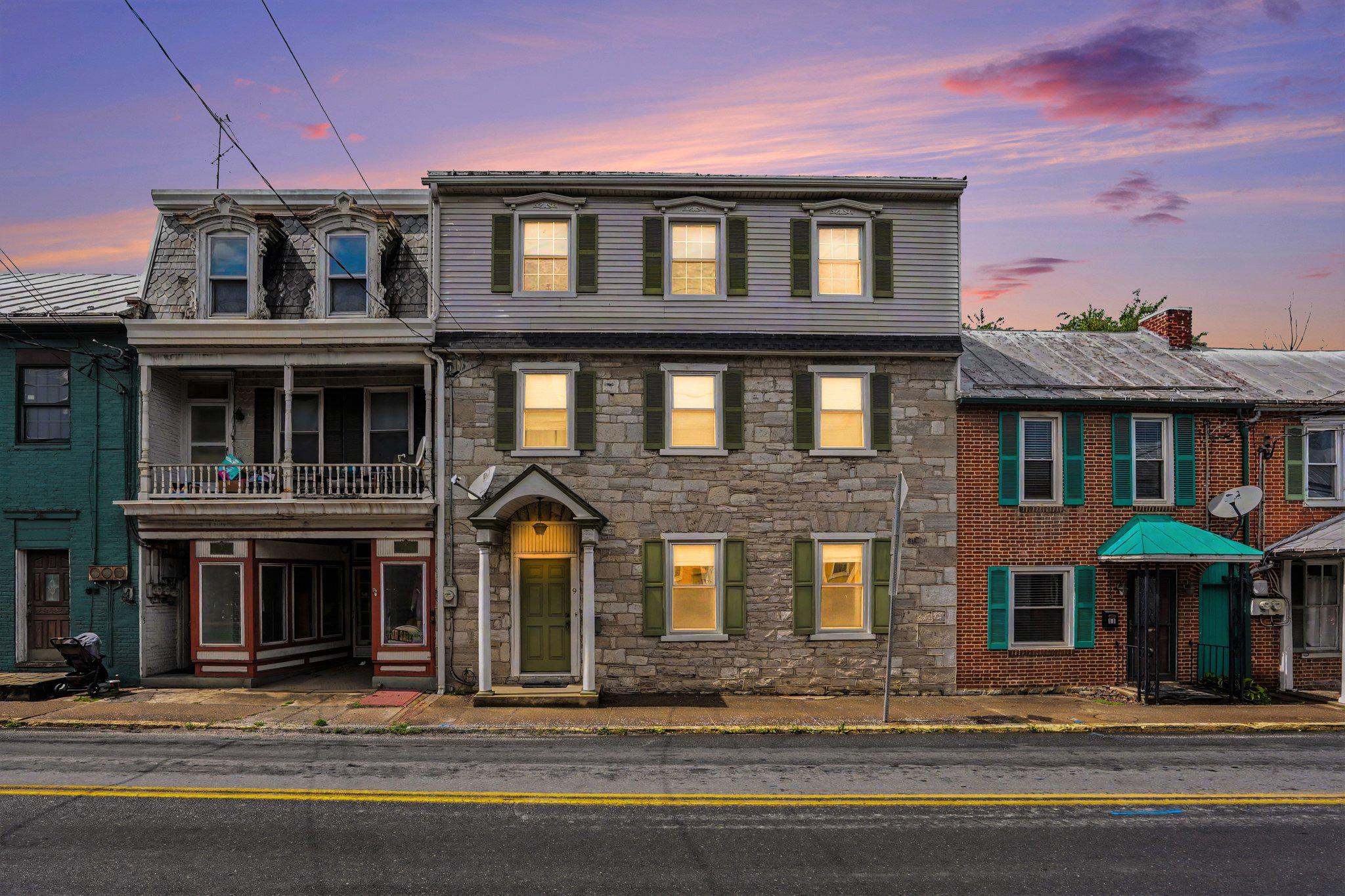 Rich in character and historic charm, 9 E Main Street in Newville offers a beautifully maintained stone home with modern updates and endless potential. Featuring 3 bedrooms and 2 full bathrooms, this turnkey property blends timeless craftsmanship with everyday comfort.

Step inside to a grand foyer with an open staircase, original millwork, hardwood floors, and inviting living spaces filled with warmth and character. The formal living and dining rooms feature charming faux fireplaces, while the spacious country kitchen offers an eat-in area perfect for everyday living and entertaining. Additional main-level features include a Florida room, first-floor laundry, and a full bathroom.

Upstairs, you’ll find three generously sized bedrooms and another full bath. The third floor has already been studded out and is ready for the next owner to finish if desired, offering the opportunity for additional bedrooms, office space, or a bonus area. The current owner did not need the extra space, but the potential is already there for future expansion.

Important updates include a newer furnace and central air system, along with interior painting completed not long ago, helping make this home move-in ready. Outside, the oversized 4-car garage provides exceptional storage and workshop space, with two bays currently used for parking and the additional bays serving as storage/workshop areas. Additional parking is also available behind the property.

Conveniently located in the heart of Newville near local shops, dining, parks, and commuter routes, this home offers the perfect mix of historic charm, functionality, and future potential.