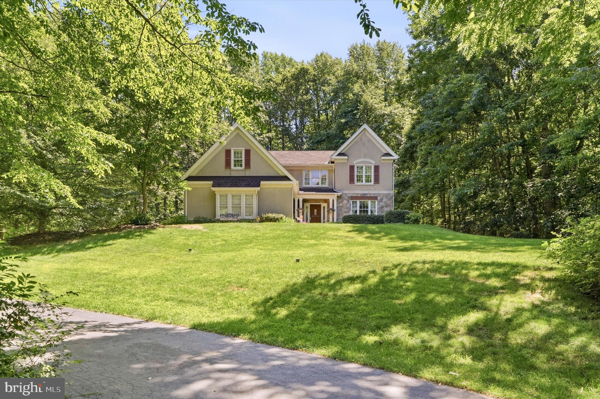 Welcome to 16 Ryan Lane, a meticulously maintained one-owner custom contemporary home tucked away on a private cul-de-sac in desirable West Brandywine Township. Situated on 1.7 acres backing to approximately 85 acres of wooded open space, this exceptional property offers privacy, quality craftsmanship, and over 2,800 square feet of thoughtfully designed living space, plus an additional 1,400+ square feet of heated and cooled lower-level space ready for future finishing. Built by Entrekin Builders, renowned for their super-insulated custom homes, this 4-bedroom, 2.5-bath residence has been lovingly cared for by its original owners since 1994. From the moment you arrive, you'll appreciate the stone-covered front porch, expansive driveway with parking for 10-12 vehicles, and peaceful setting. Inside, a tiled foyer welcomes you with soaring vaulted ceilings, abundant natural light from Andersen windows, custom architectural details, a dramatic open staircase, and hardwood flooring flowing through the formal living and dining rooms. The impressive great room serves as the heart of the home and features a striking double-sided propane fireplace shared with the adjoining media/flex room—ideal as a home office, playroom, or additional gathering space. The spacious kitchen offers 42-inch cherry cabinetry, a walk-in pantry, propane cooktop, newer GE wall oven, updated dishwasher, built-in microwave, coffee station, breakfast bar seating, and a sunny dining area. A pocket door provides convenient access to the formal dining room while maintaining an open flow to the great room. The main level also includes a wet bar, powder room, oversized laundry room with utility sink, access to the oversized two-car garage, and direct access to the expansive two-tier Trex deck. Upstairs, the private primary suite features a sitting area, vaulted ceiling, two large walk-in closets, dual vanities, whirlpool tub, and separate shower. Three additional generously sized bedrooms offer walk-in closets, custom built-ins, cedar-lined storage, and ample closet space throughout. The walkout lower level presents incredible potential with plumbing already in place for a full bath, space for additional bedrooms, a family room, workshop, and storage areas. Superior insulated concrete walls, an insulated floating floor system, and existing heating and cooling make future finishing remarkably easy. Step outside and enjoy the newer Trex decking overlooking the serene wooded backdrop—perfect for entertaining, morning coffee, or simply enjoying the beauty of every season. Recent improvements provide exceptional peace of mind, including a new Amana HVAC system (2024), acid neutralizer system (2024), tankless propane water heater (2021), additional 100-amp subpanel (2025), rear Trex deck (2025), and garage door openers (2026). Additional features include a premium 50-year CertainTeed Grand Manor roof, oversized insulated two-car garage, deep private well, and no HOA. A rare opportunity to own a quality-built custom home surrounded by nature while remaining conveniently located near major routes, parks, golf courses, shopping, and dining. Homes of this caliber, setting, and condition are seldom offered—schedule your private tour today.